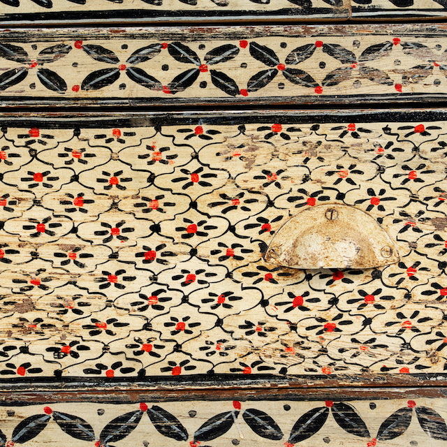 Close up image of a hand-painted Indian display cabinet with engraved Sanskrit motifs, drawer and compartments – unique Indian furniture made from recycled wood with artisanal detail.