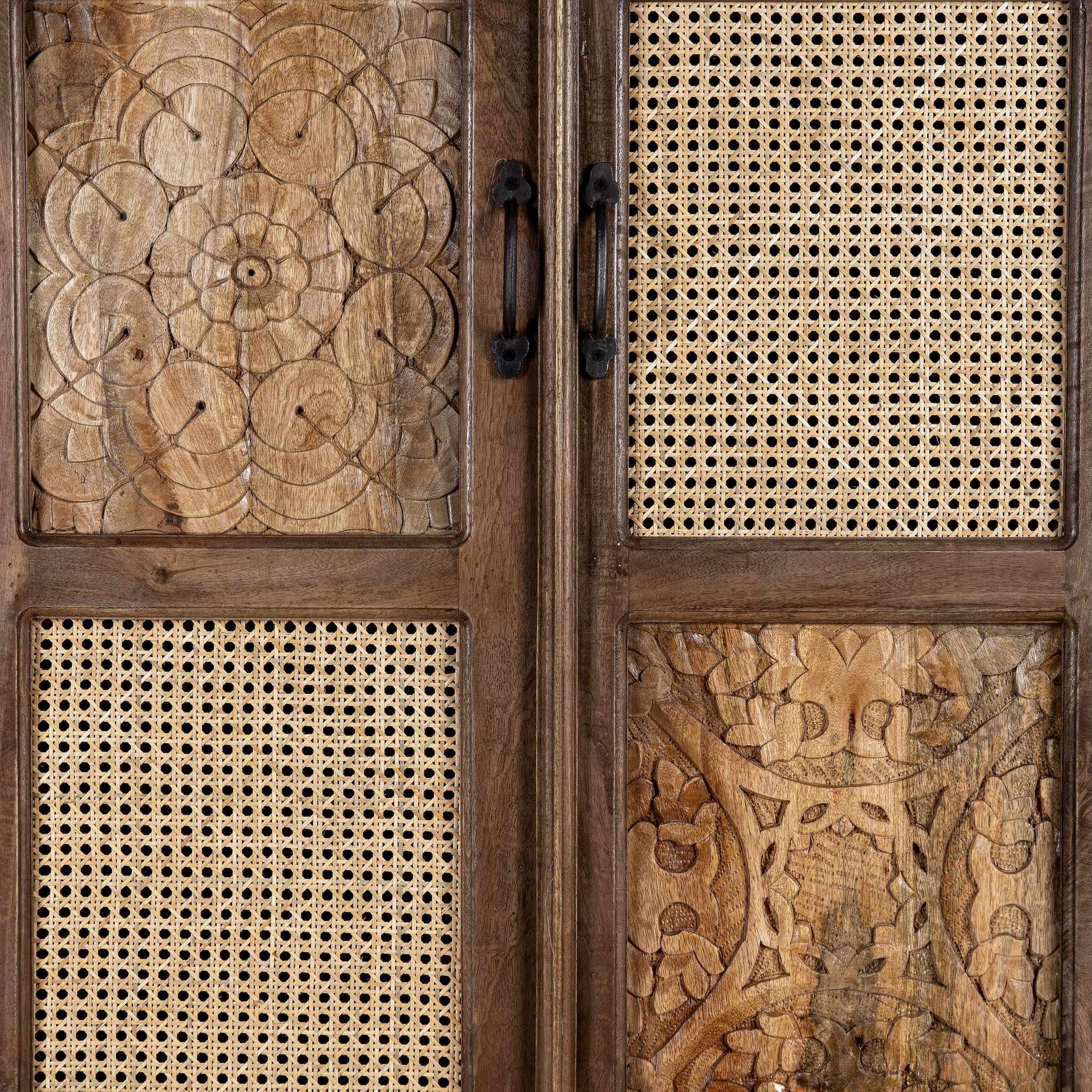 close up view of a hand carved mango wood cabinet with floral design, 2 doors and one drawer in vintage design.