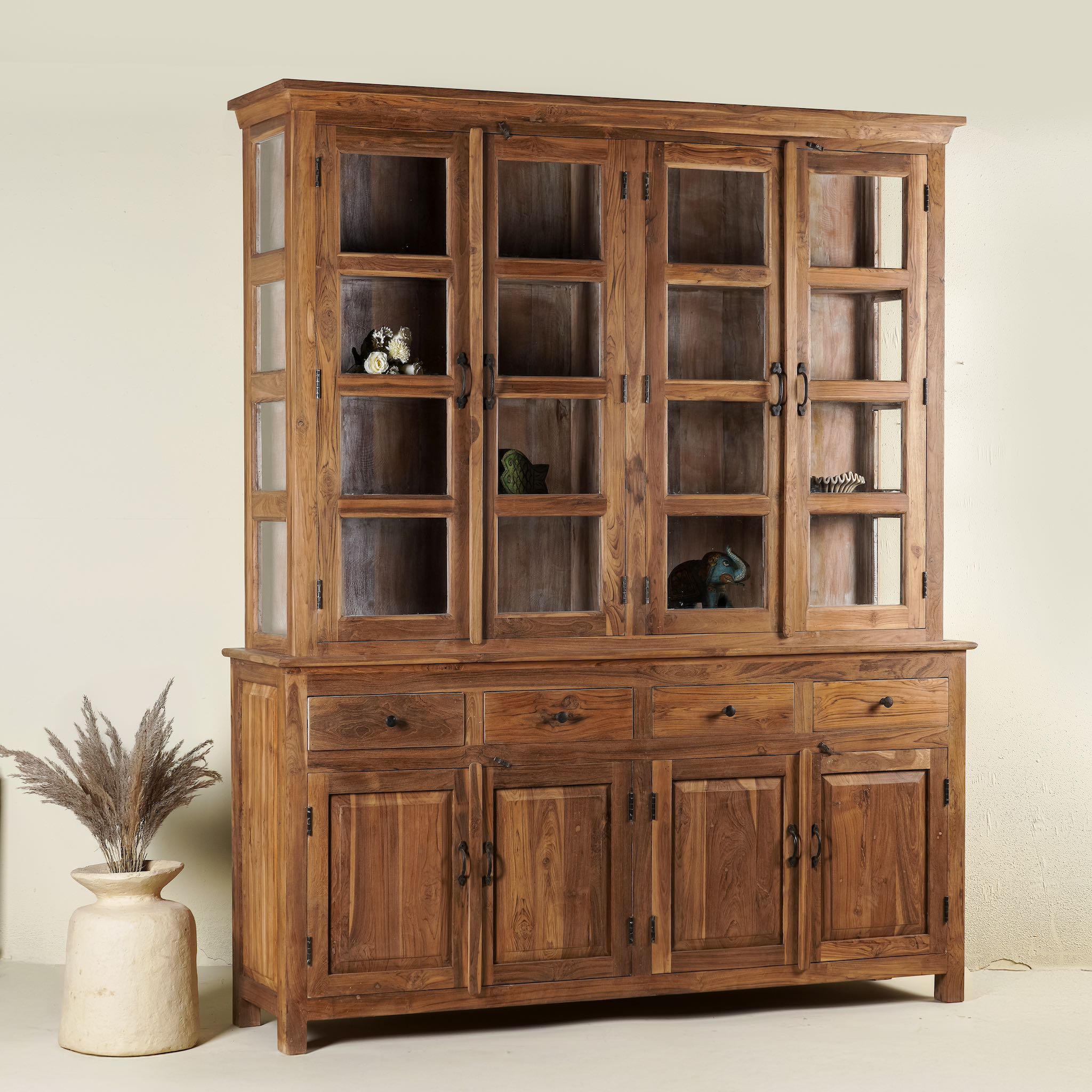 Two-part showcase cabinet made from reclaimed teak wood, featuring glass-panel upper doors for display, four drawers for storage, and lower cabinets with solid wood doors in a natural finish.