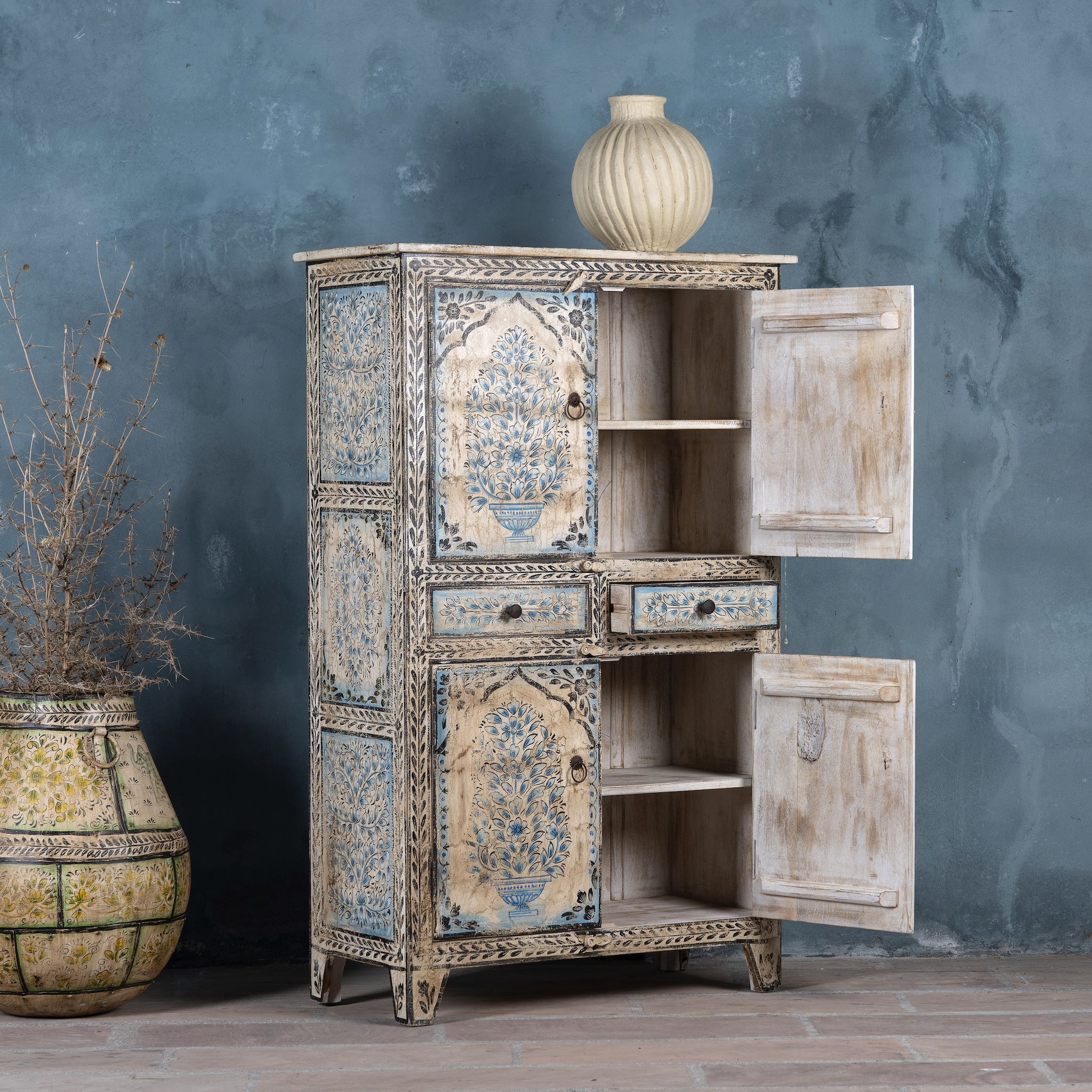 Open door image of a hand-painted wooden cabinet made from reclaimed wood with blue floral motifs – sustainable furniture with artistic charm and vintage appeal.