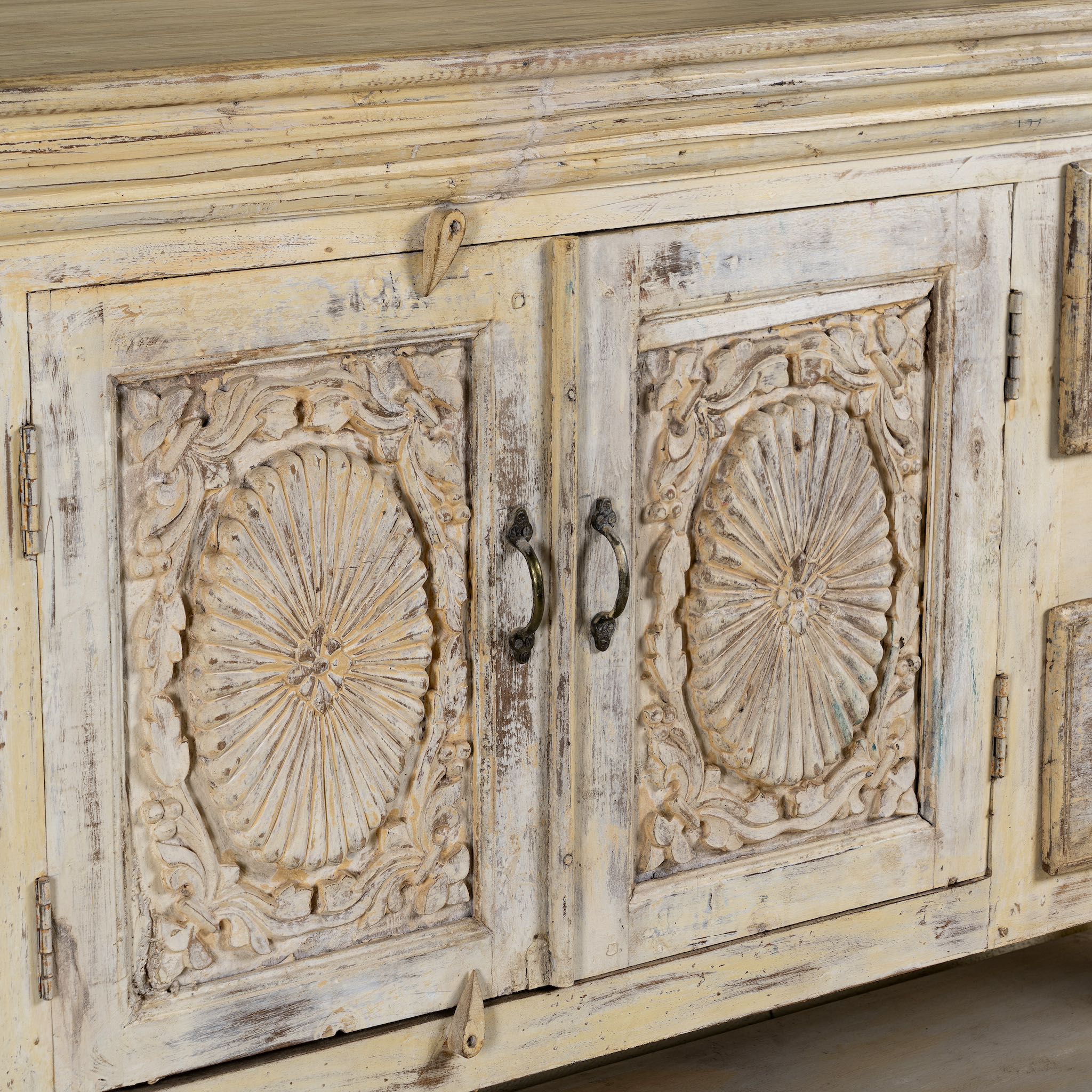 Close up image of a vintage console table made from reclaimed wood with carved teak front, two drawers, four cupboards, and lower shelf, 201 × 42 × 100 cm.