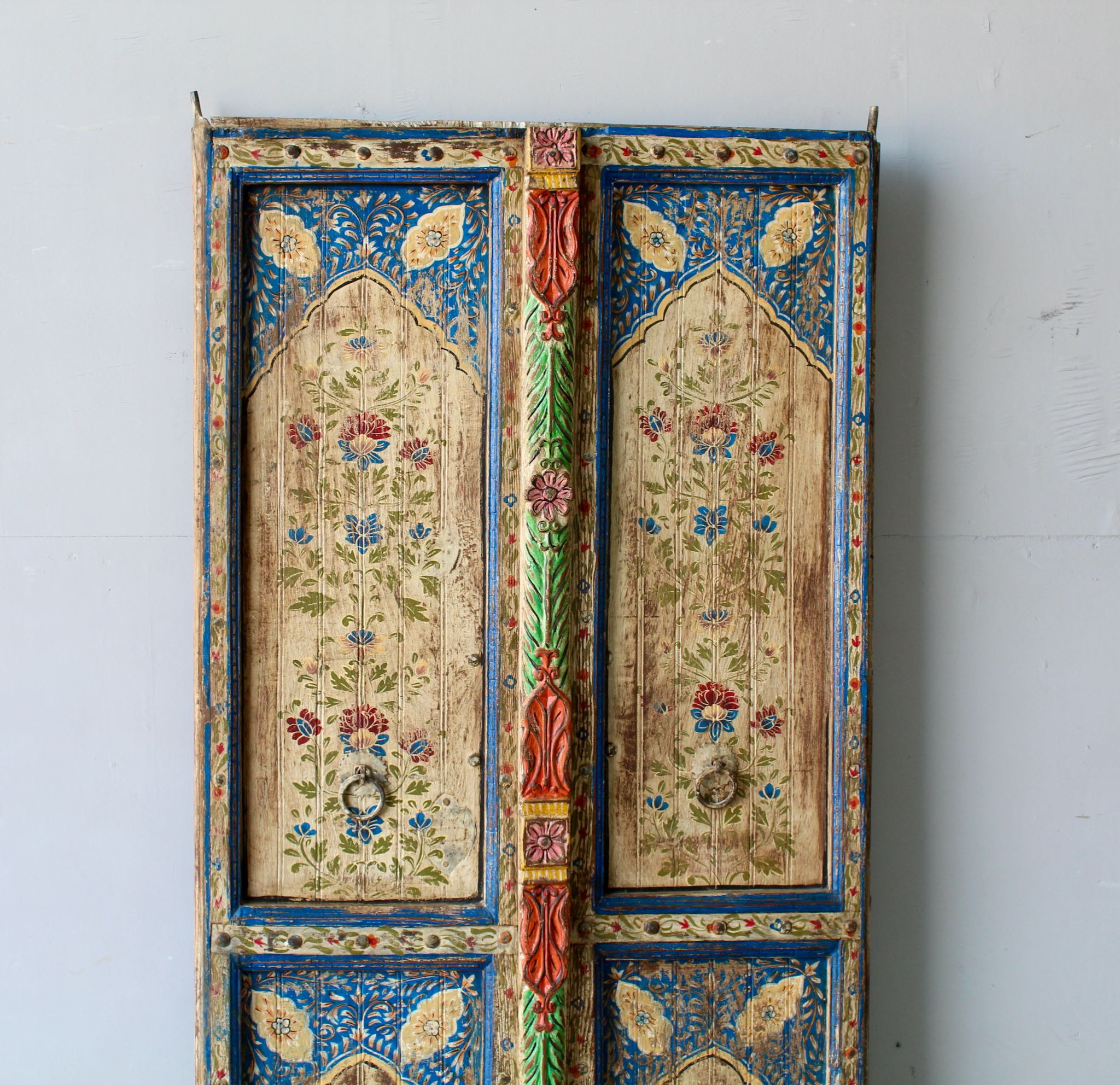 Close up image of a hand-painted Indian antique door panel with floral motifs, vintage wall panels, and timeless Mughal-style design for vintage home decor.