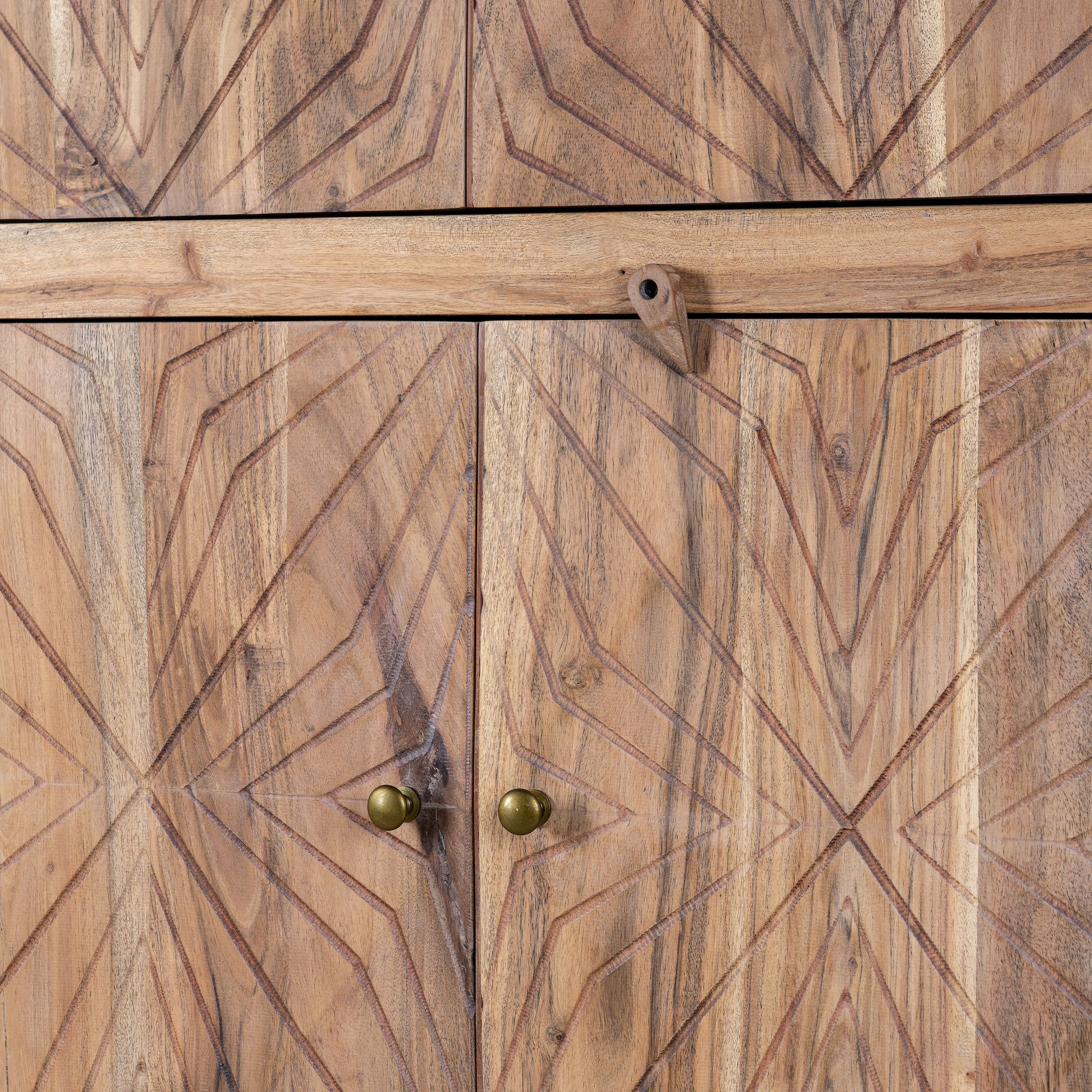 Close up view of a carved acacia wood wardrobe with floral detailing and brass handles; artisanal acacia wood furniture, 100 × 40 × 180 cm.