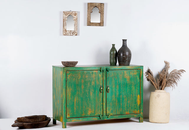 Side angle image of a handcrafted sideboard made from reclaimed teak and recycled wood, hand-painted in green – sustainable furniture with artistic character.