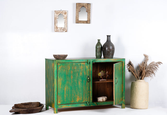 Side angle image with open door of a handcrafted sideboard made from reclaimed teak and recycled wood, hand-painted in green – sustainable furniture with artistic character.