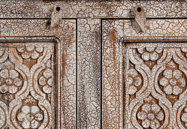 Close up image of a hand‑carved vintage style mango wood sideboard with distressed floral lattice panels, 150 × 40 × 90 cm.