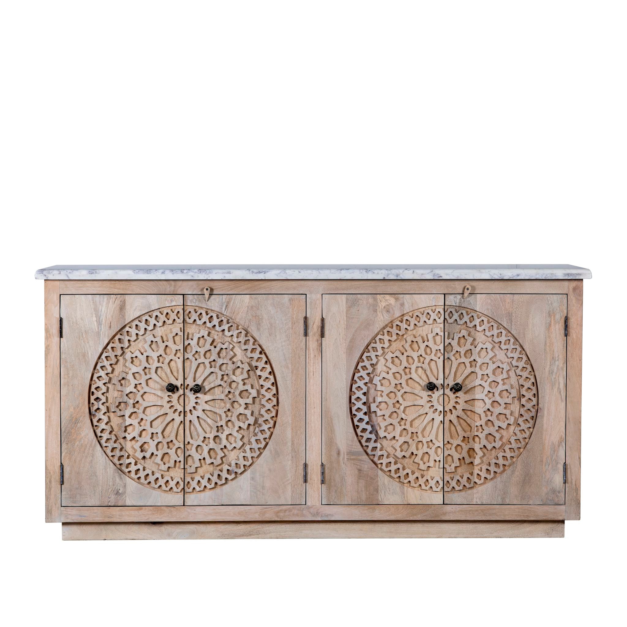 White background picture of a Acacia wood sideboard with circular carvings, 4 doors and iron handles with a white marble top.