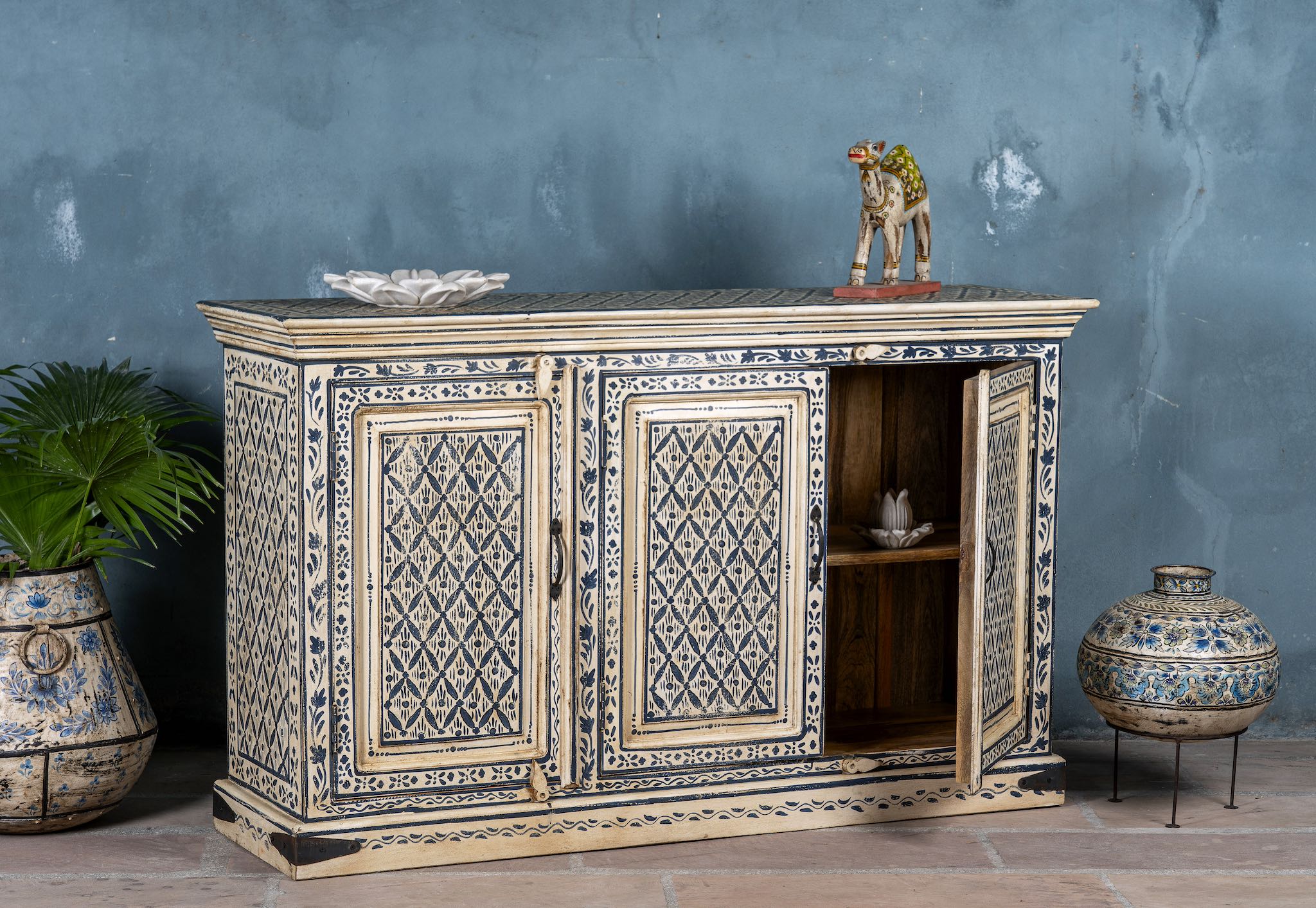 Side angle image with open door of a hand-painted sideboard made from reclaimed wood in indigo and cream tones – a handcrafted piece of reclaimed wood furniture perfect for hand painted interiors.