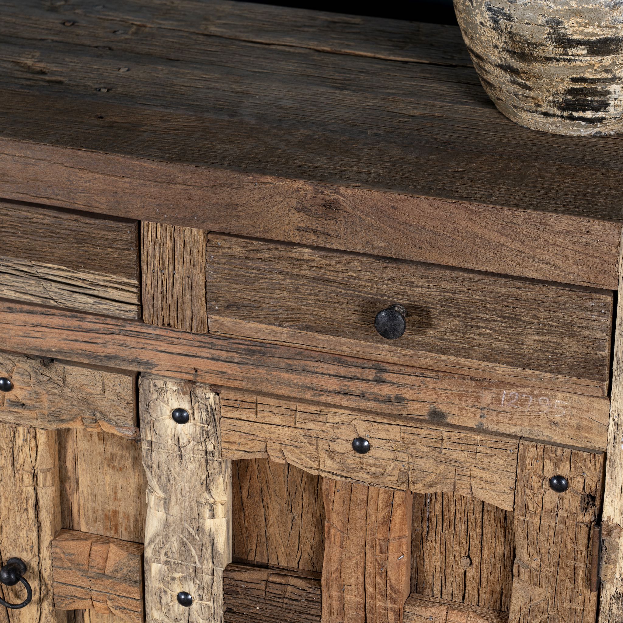 Close up view of a driftwood cabinet made from reclaimed wood with paneled doors, drawers, and rustic finish, 90 × 40 × 90 cm.