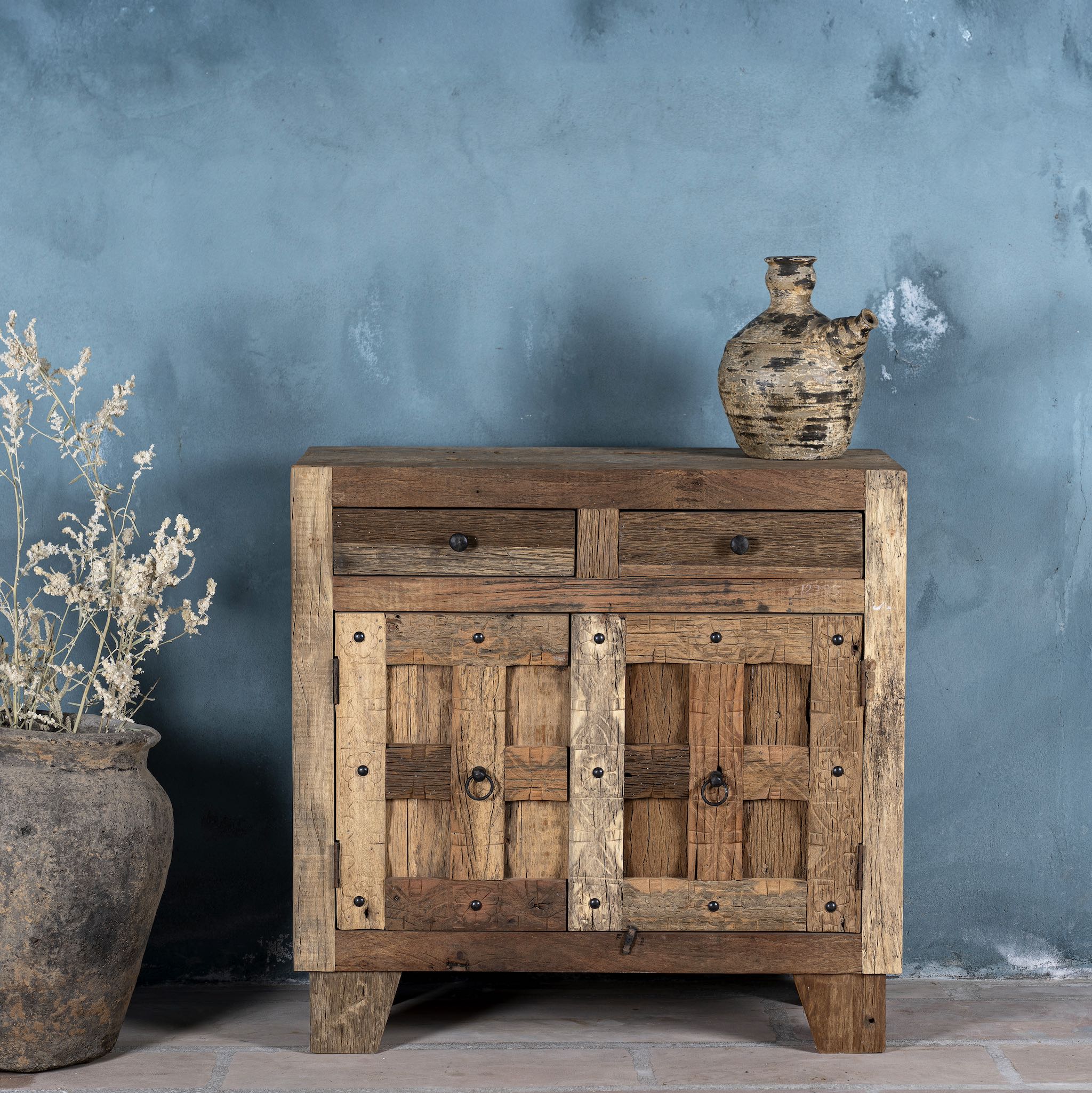 Front view of a driftwood cabinet made from reclaimed wood with panelled doors, drawers, and rustic finish, 90 × 40 × 90 cm.