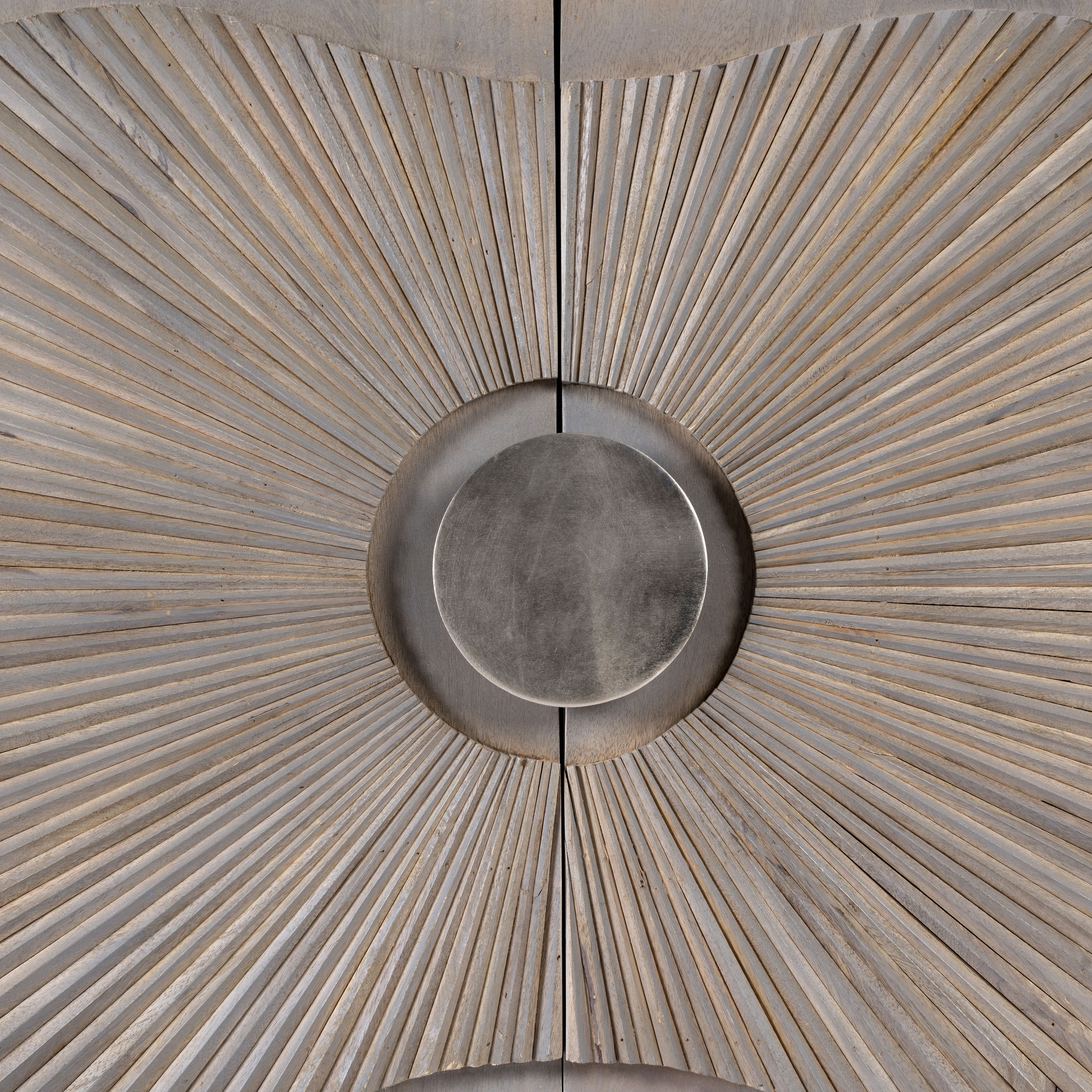 Close up image of a handcrafted mango wood sideboard with floral-inspired sunburst carving, grey wash finish, and silver accents – mid century style furniture for elegant living spaces.