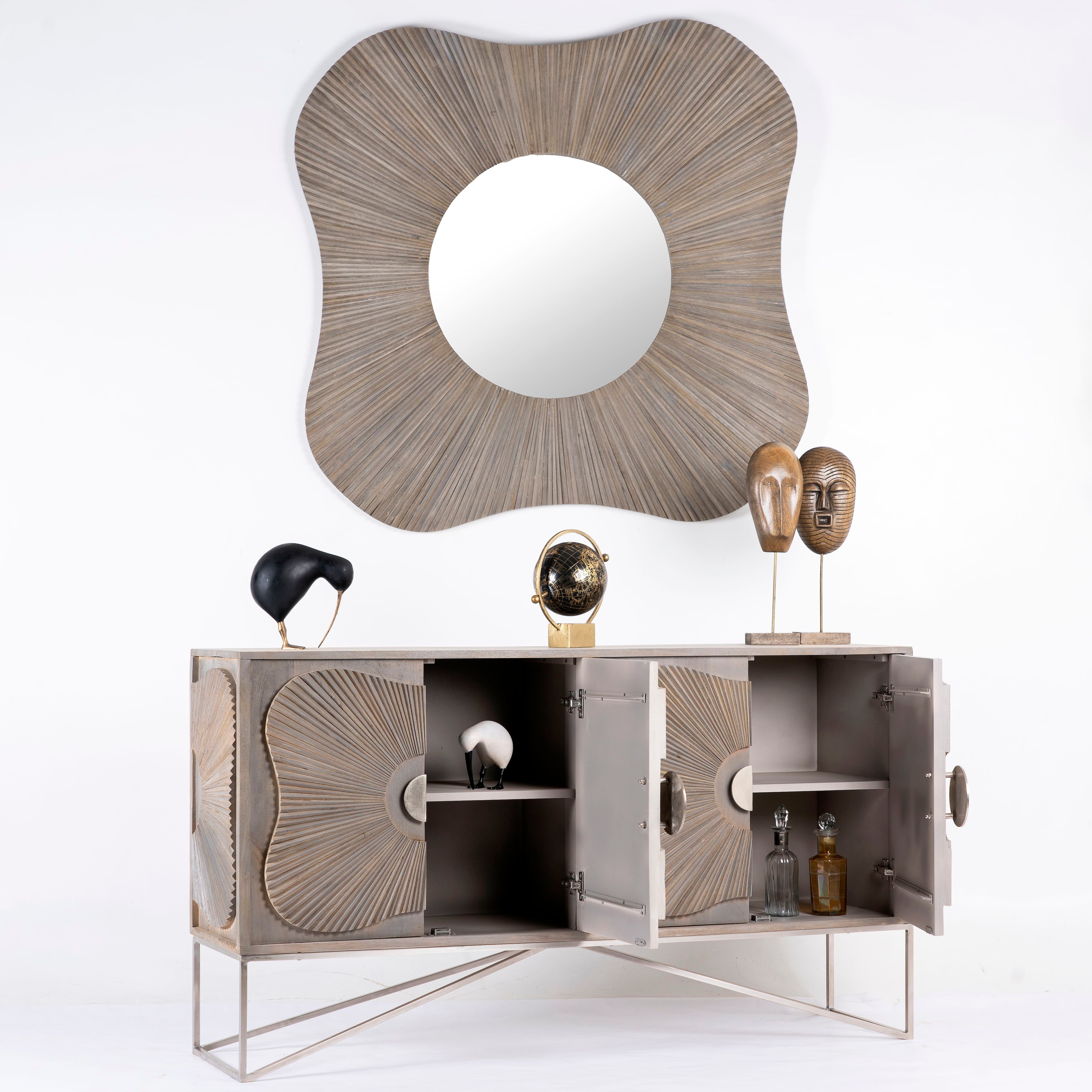 Side angle image with open door of a handcrafted mango wood sideboard with floral-inspired sunburst carving, grey wash finish, and silver accents – mid century style furniture for elegant living spaces.