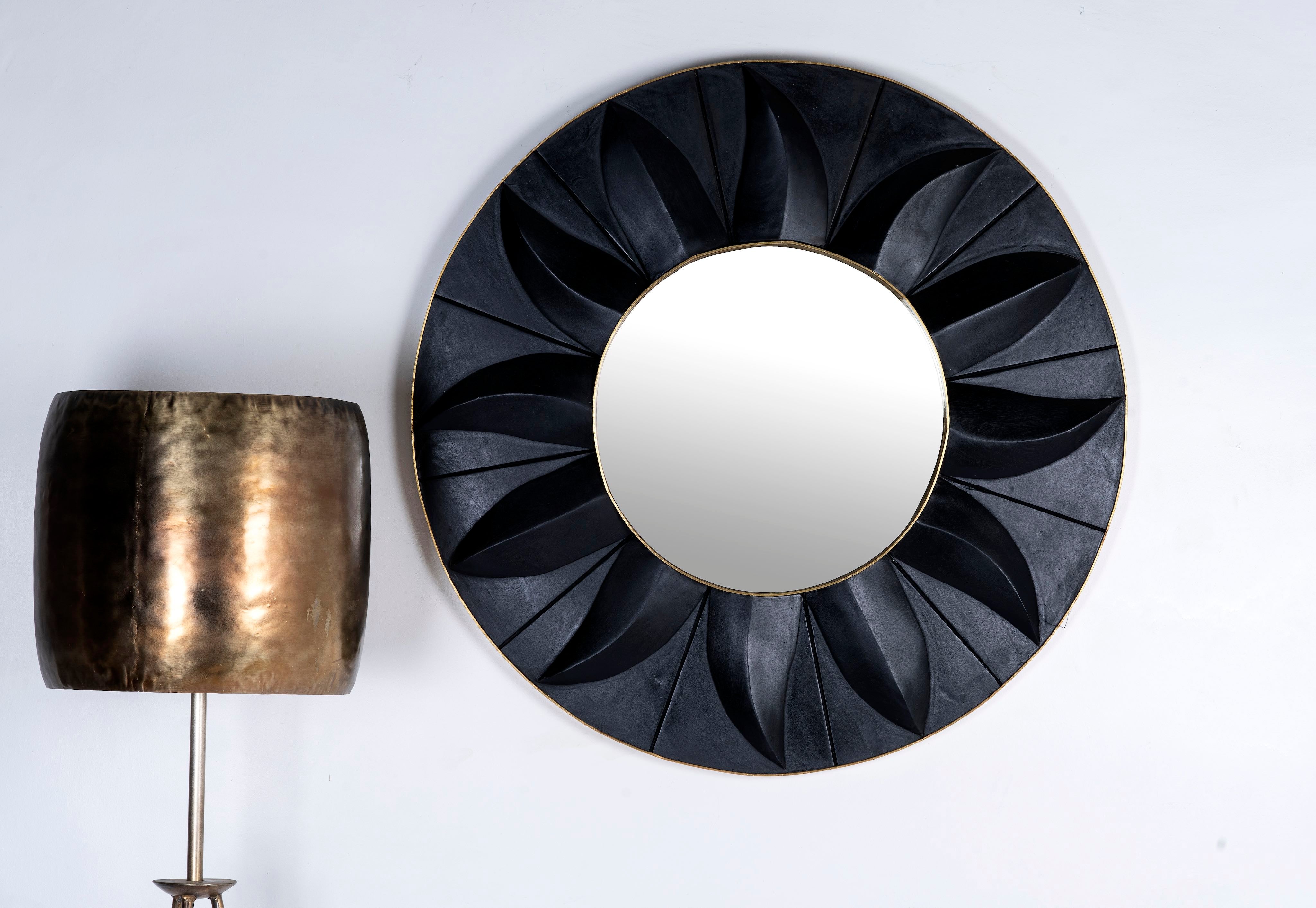 Black mango wood cabinet with carved circular patterns and brass-plated iron base, 91 × 43 × 111 cm.