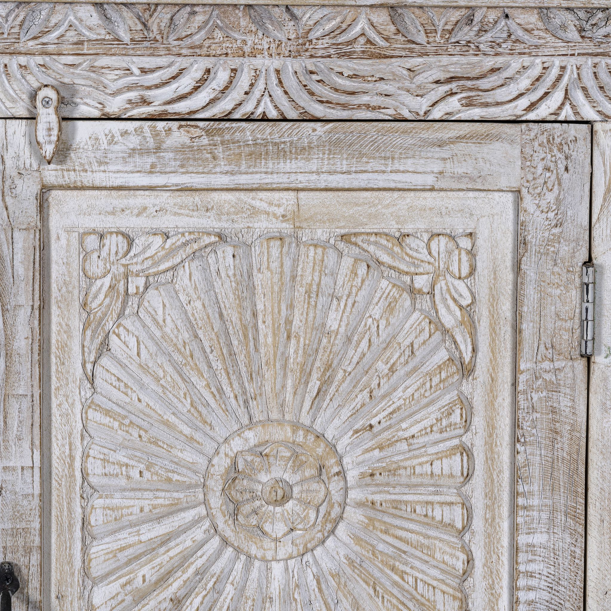 Close up image of a white washed wood cabinet with hand-carved floral design, Moroccan-style reclaimed wood furniture, 134 × 60 × 45 cm.