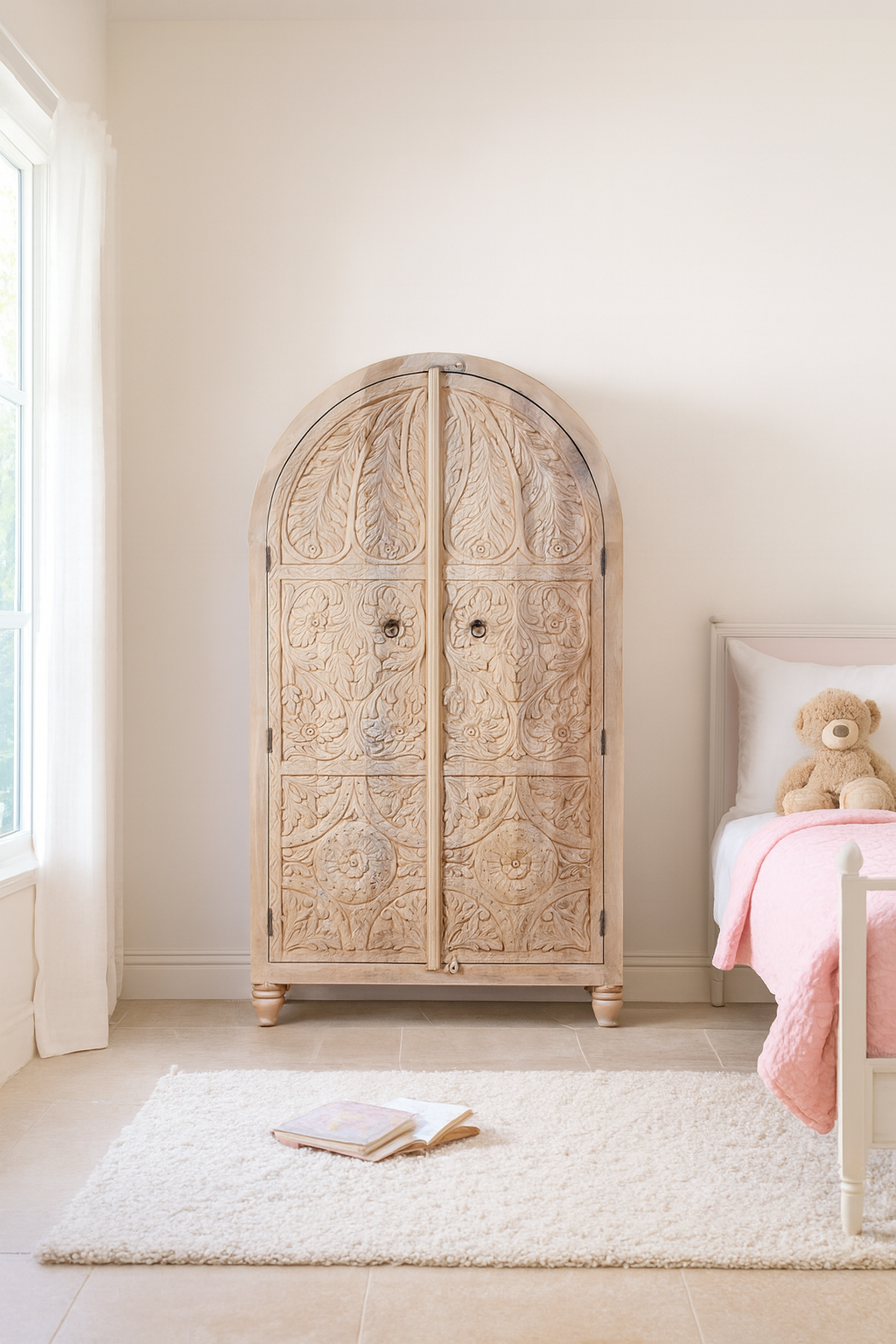Lifestyle image of a handcrafted mango wood wardrobe with arched top and floral carving – Tamia by Om Home & Garden, unique furniture with Ibiza-style charm for living rooms and bedrooms.