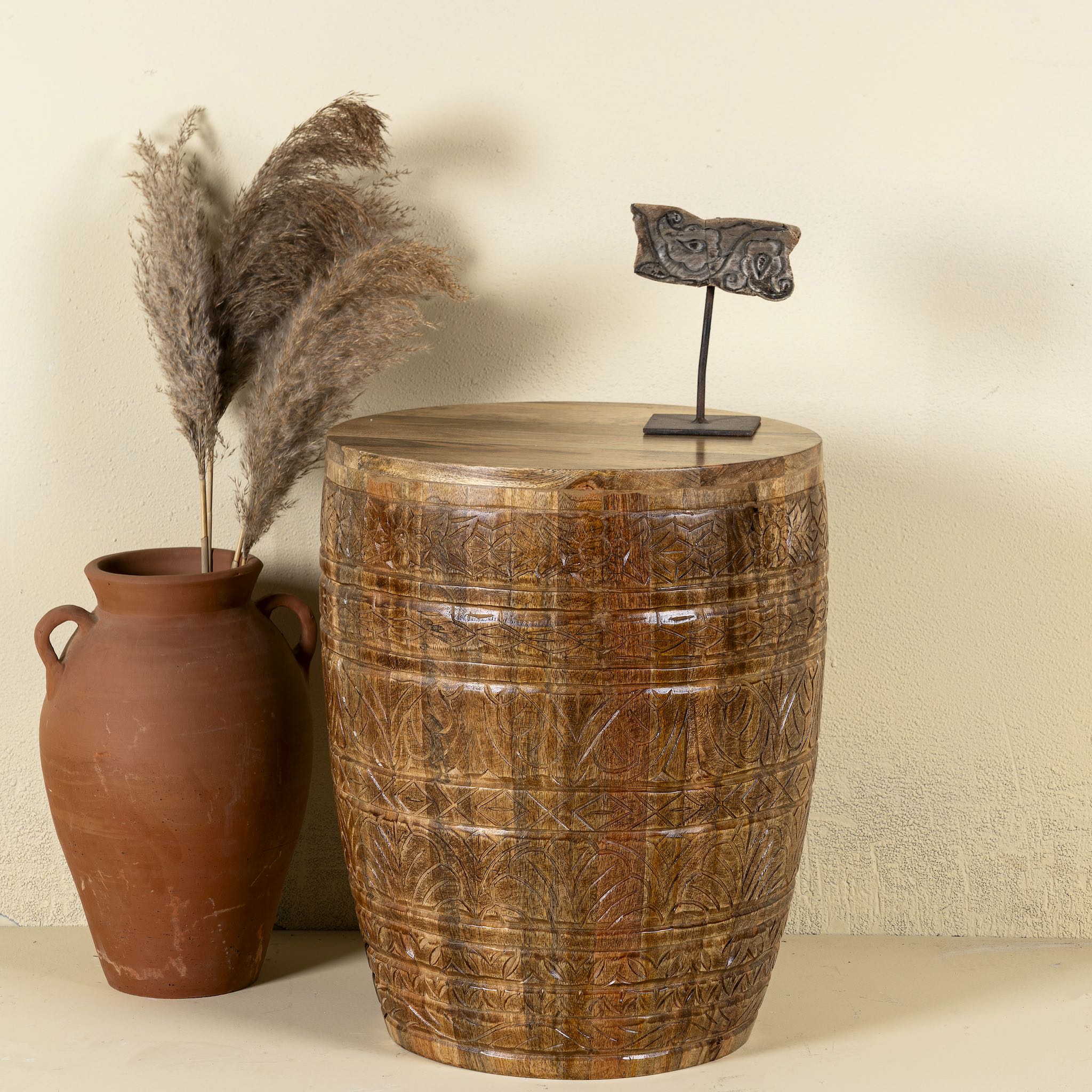 Hand-carved mango wood coffee table with barrel shape and warm rustic finish; vintage style coffee table, 45 cm diameter, 55 cm height.