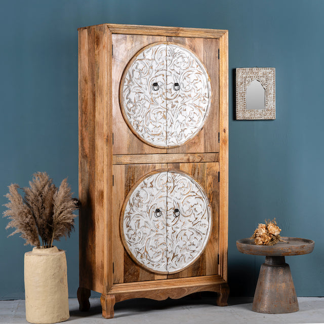 Side angle image of a mango wood wardrobe with hand-carved floral front, vintage carved wood furniture with curved legs, 180 × 90 × 40 cm.