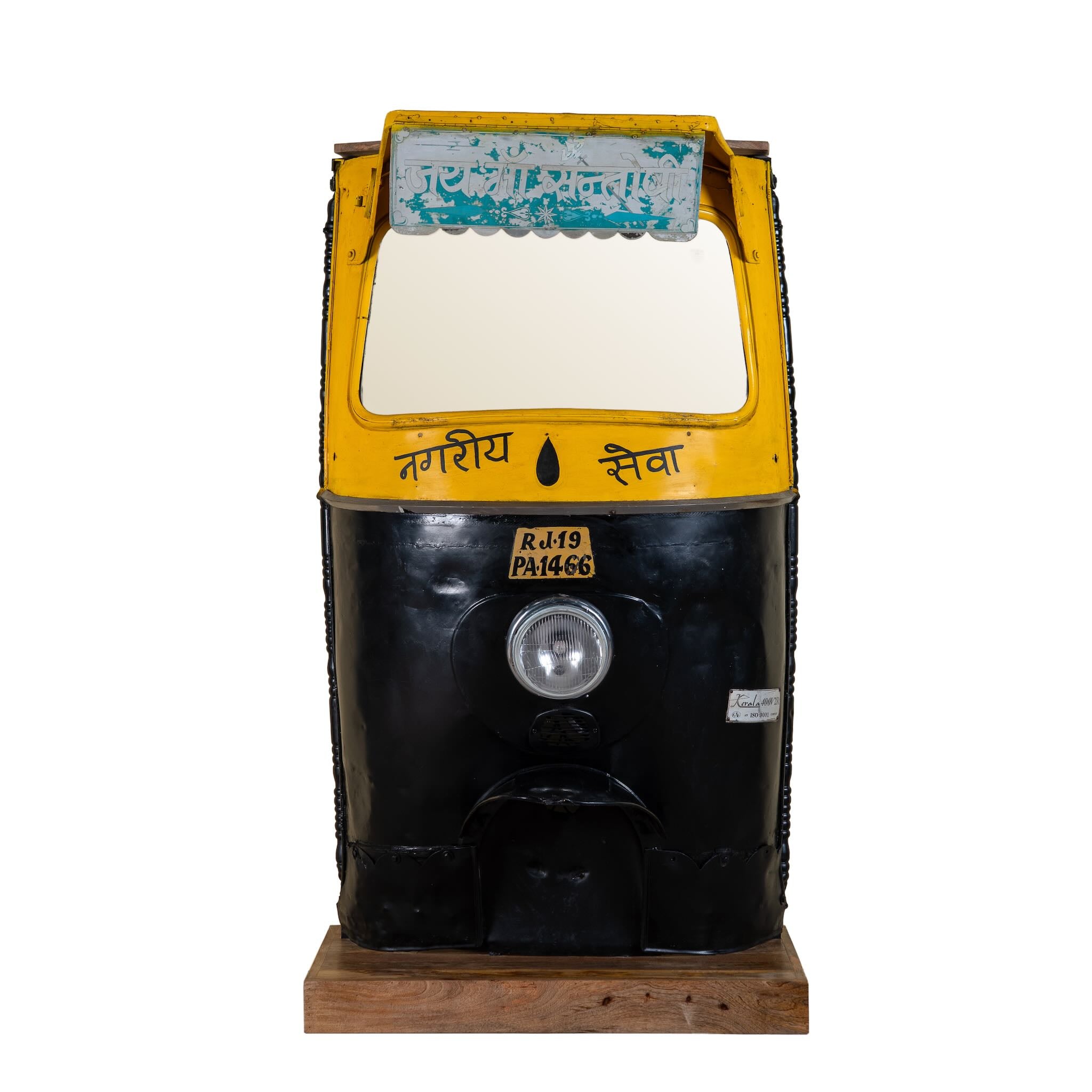 White background image of a artsy bar table made from a reclaimed Indian rickshaw front with working headlight – Zoha Riksha bar model by Om Home & Garden