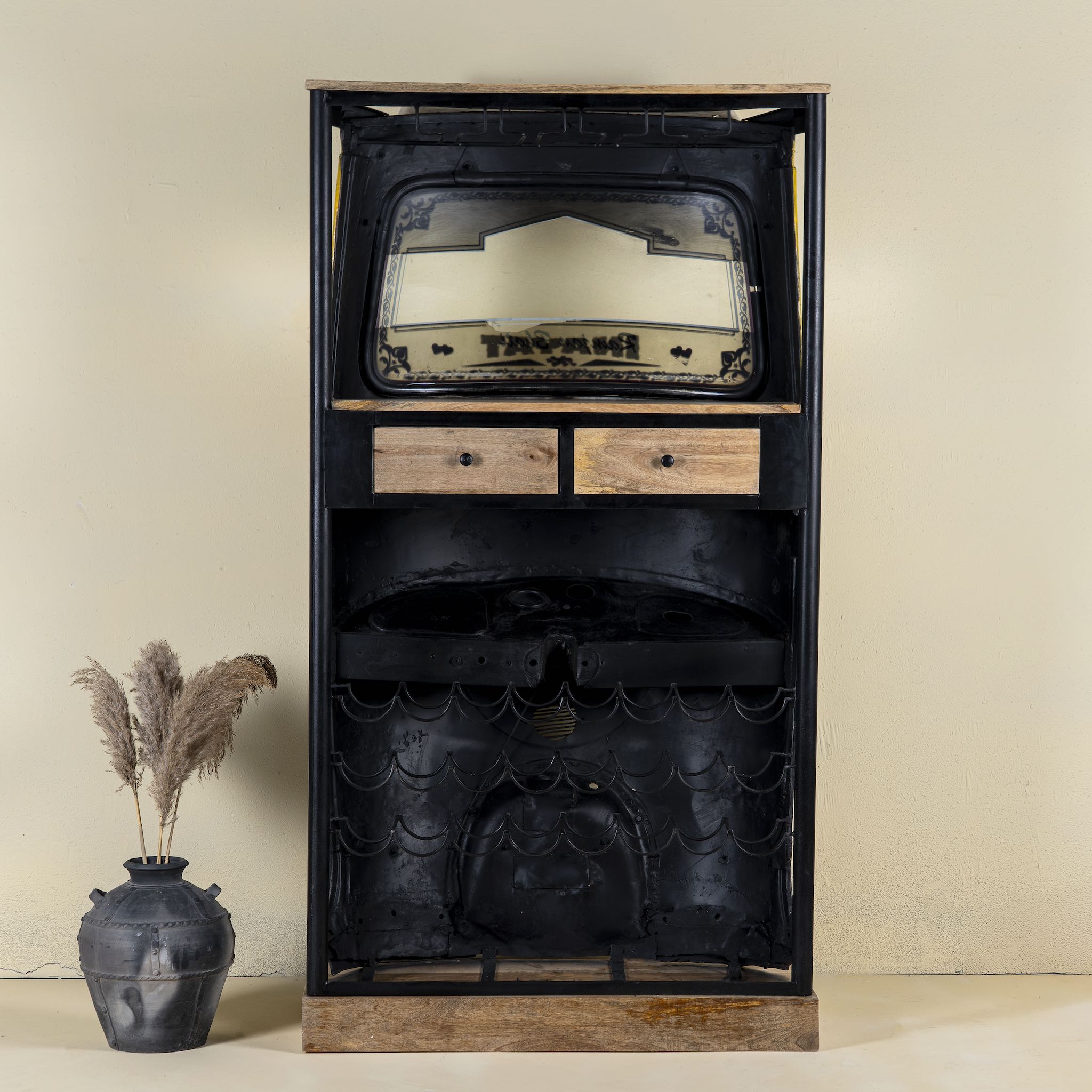 Unique bar table crafted from the front part of an old Indian rickshaw, featuring vibrant yellow and black paint with original details and functioning light.