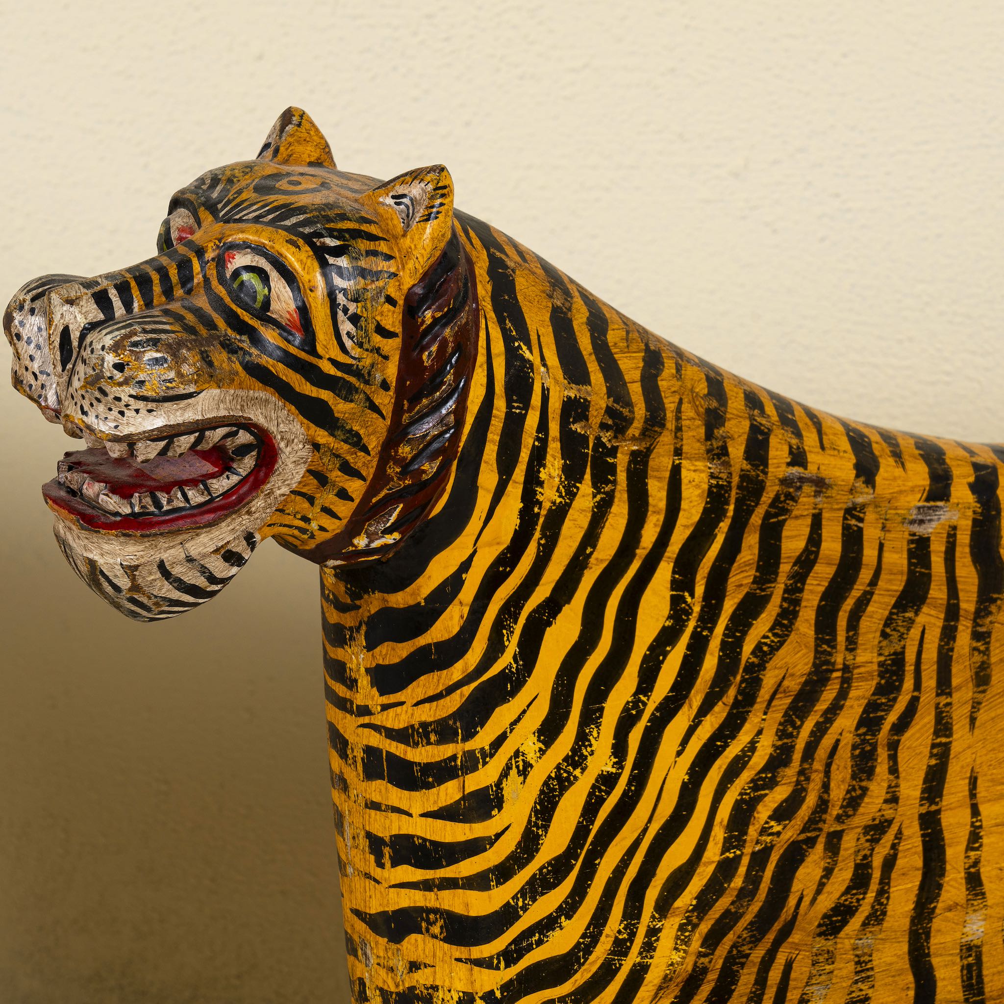 Close up view of a hand painted tiger chair made of reclaimed wood, a unique decorative furniture not only for a children room. The head of the chair can be purchased in right or left direction.