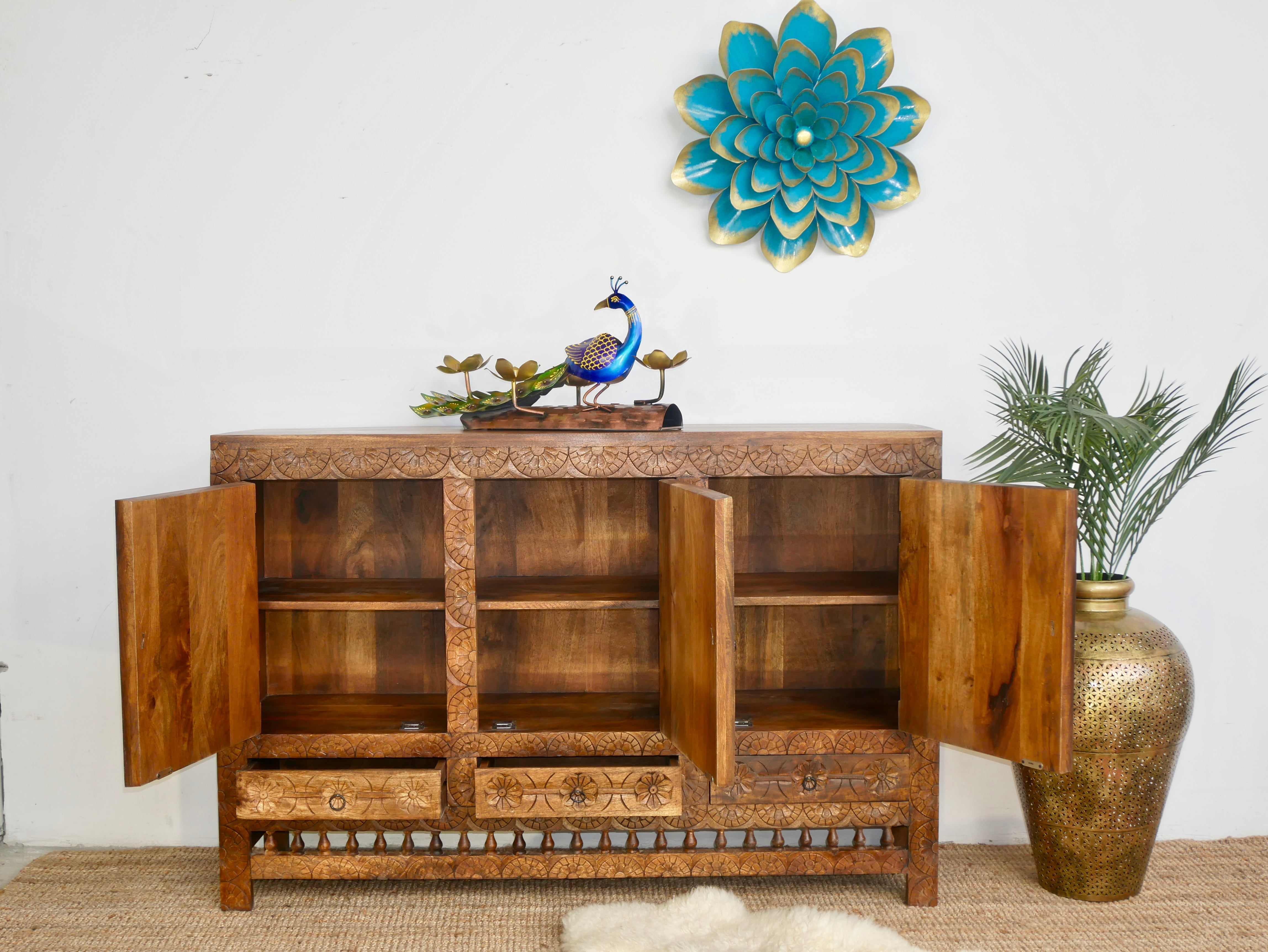 Open door image of a handcrafted traditional sideboard made from mango wood with Indian carvings and brass inlay; Indian furniture, 150 × 100 × 40 cm.