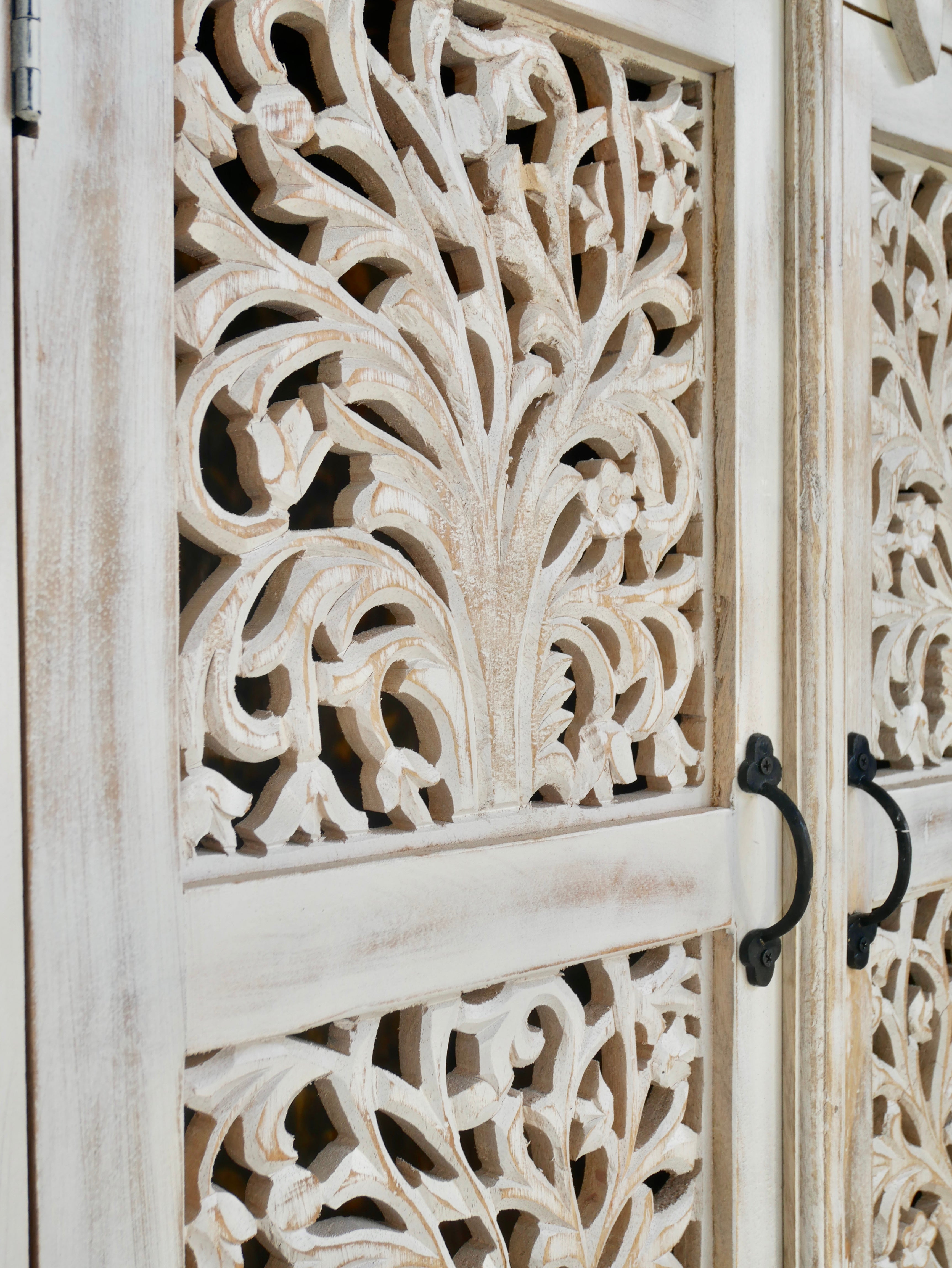 Close up image of a hand-carved mango wood cabinet with white-washed finish – artisanal furniture combining Mediterranean design and functional elegance.