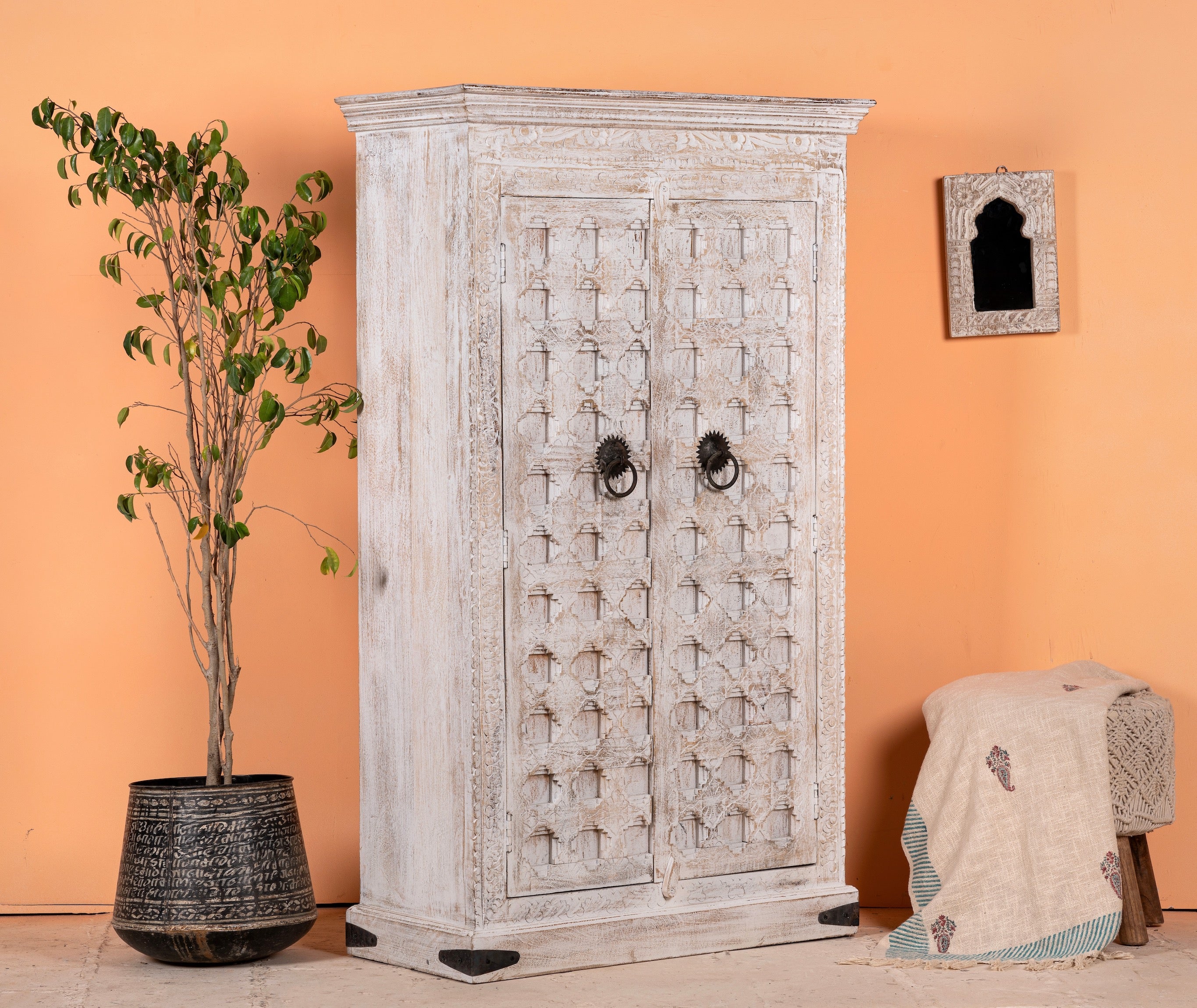 Side angle image of a handcrafted cabinet made from reclaimed wood with white-washed finish and Indian carvings – sustainable furniture and unique Indian furniture with cultural depth.