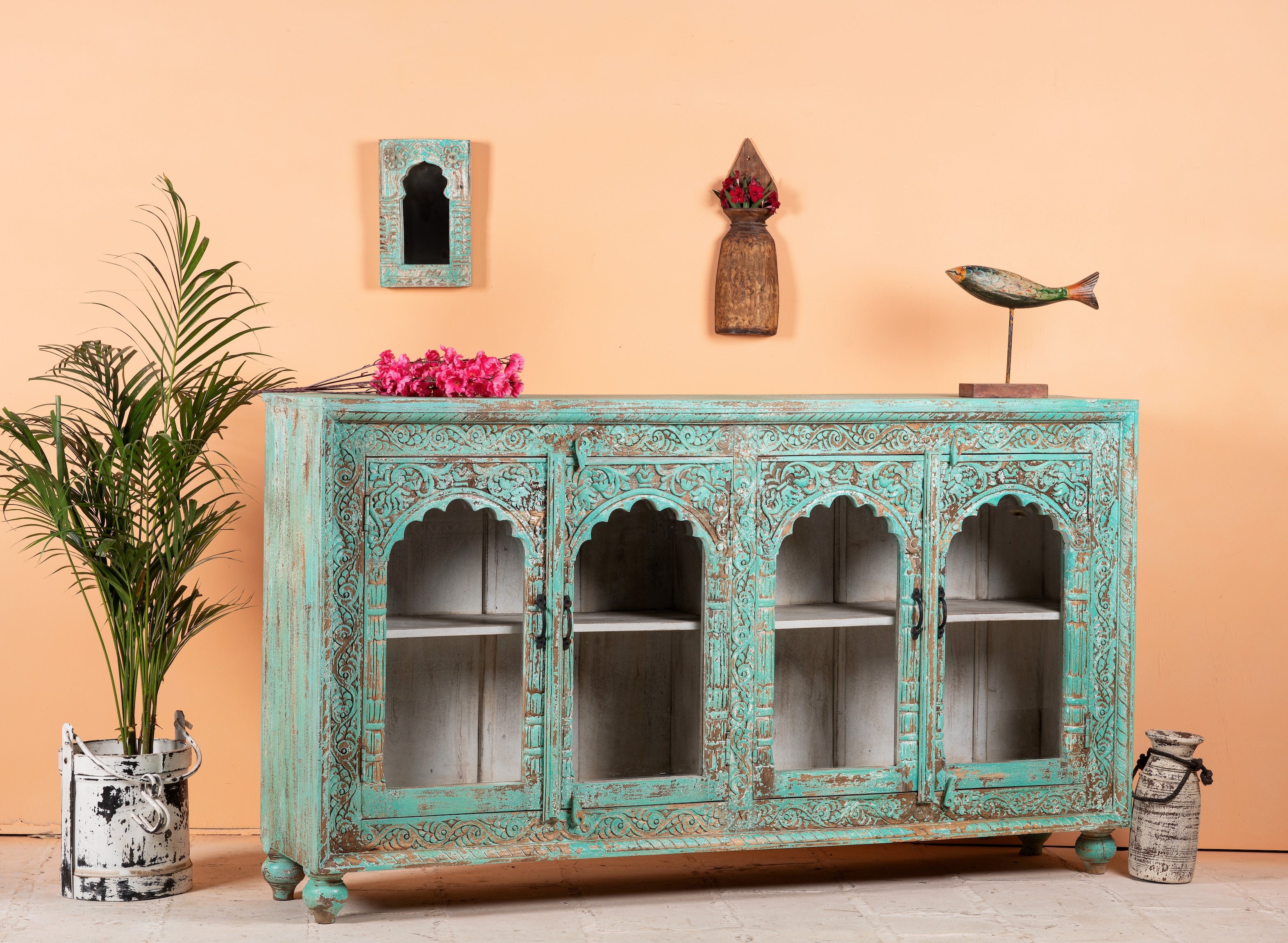 Side angle image of Jesar handcrafted turquoise-washed carved wooden sideboard with Indian motifs and open compartments; ideal as living room furniture or carved showcase, 180 × 100 × 40 cm.