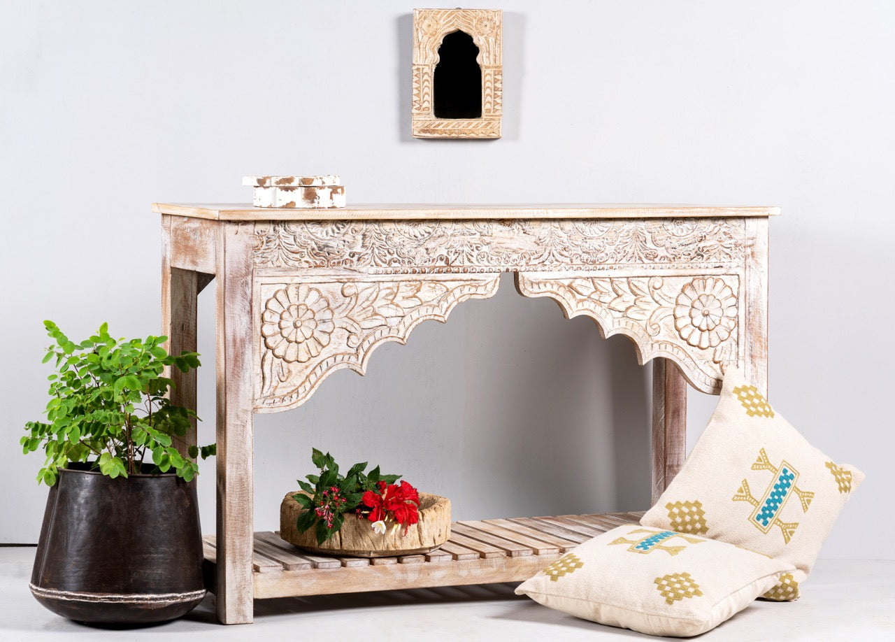 Side angle image of a Kolkata carved wood console table in solid mango wood, vintage entryway table with floral motifs and storage shelf, 130 × 84 × 44 cm.