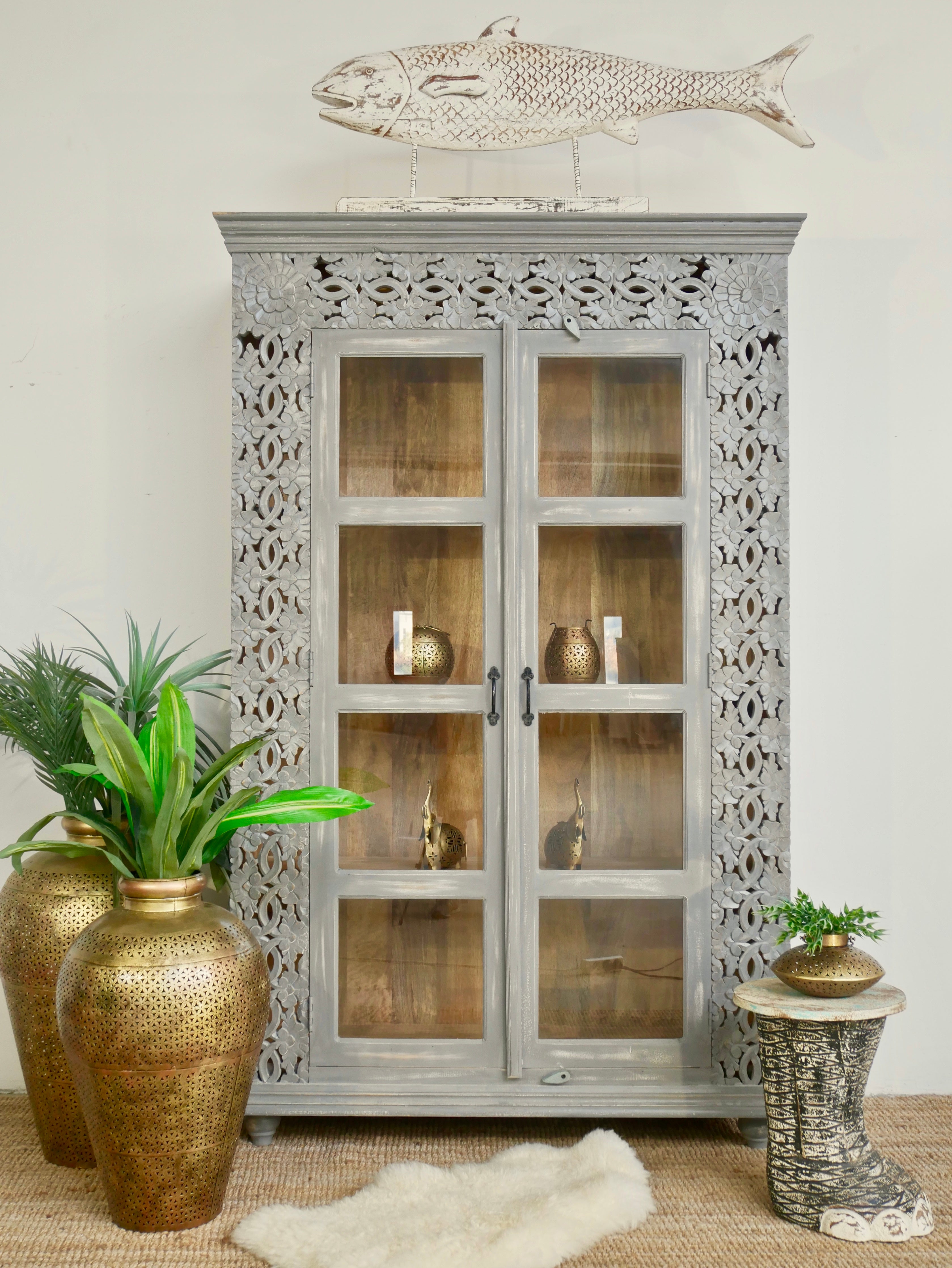 Handcrafted mango wood cabinet with glass-panelled doors and internal storage – carved wood furniture made from sustainable mango wood with unique natural grain.