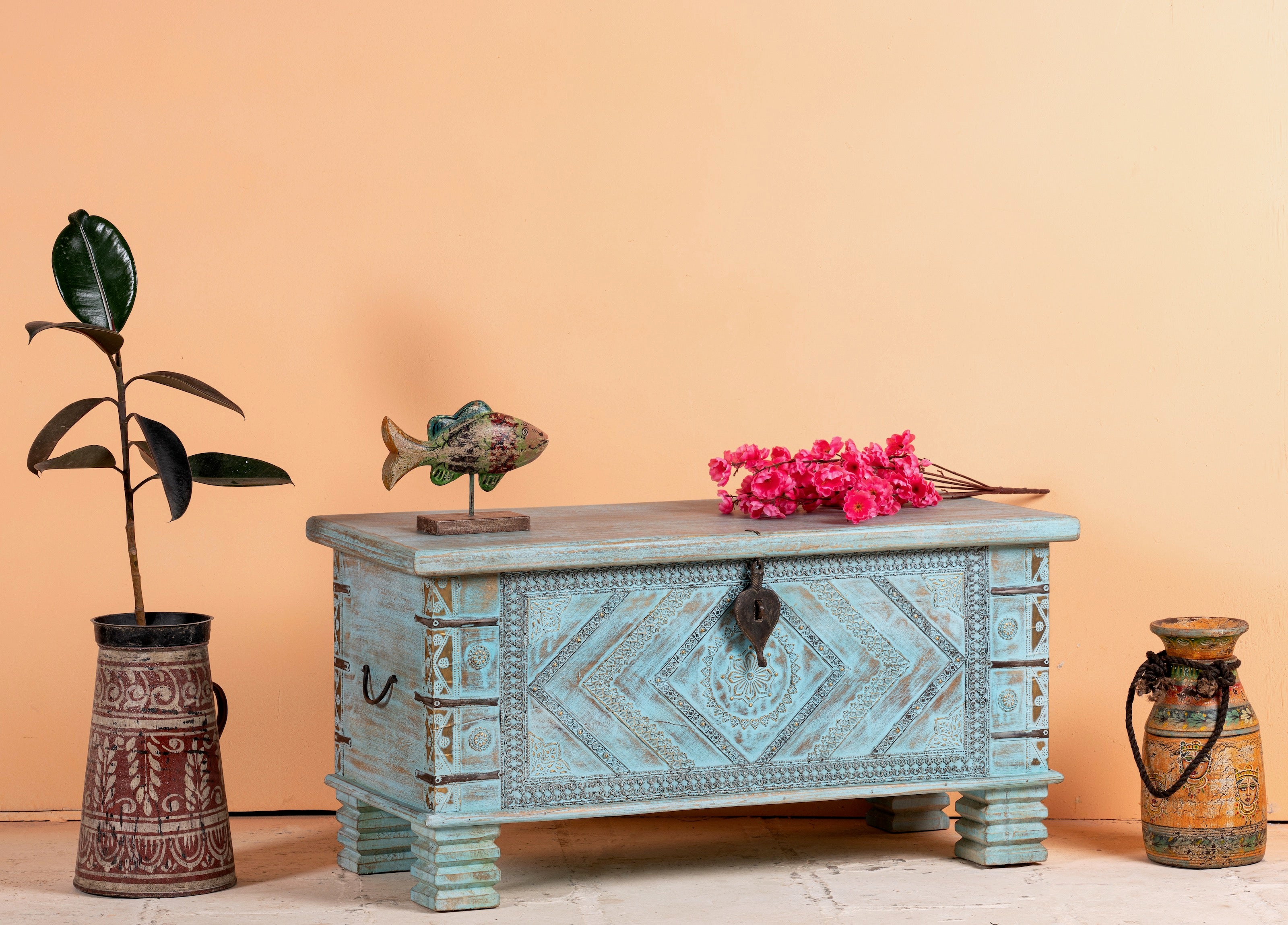 Side angle image of a blue hand-carved mango wood chest with floral and geometric carvings – wood chest box perfect for boho style storage or decorative accent.