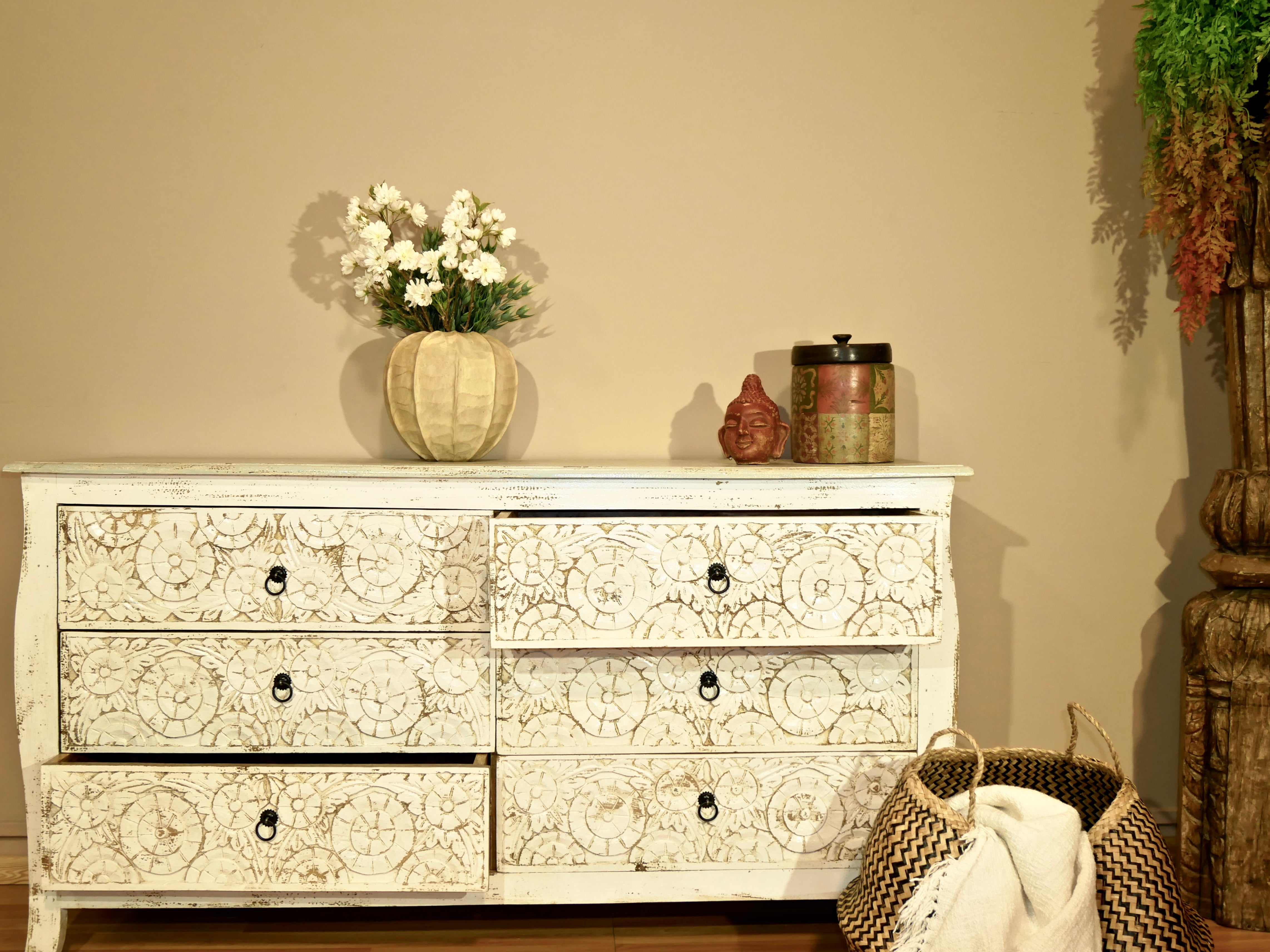 Image with open drawers of a handcrafted mango wood drawer chest with six hand-carved fronts, natural finish, and Mediterranean vintage furniture style – Nagpur by Om Home & Garden.