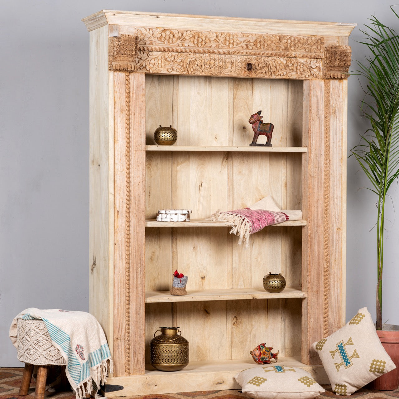 Side angle image of a handcrafted shelf with reclaimed teak wood frame and mango wood body – unique Indian furniture with carved detailing and rustic teak wood finish.