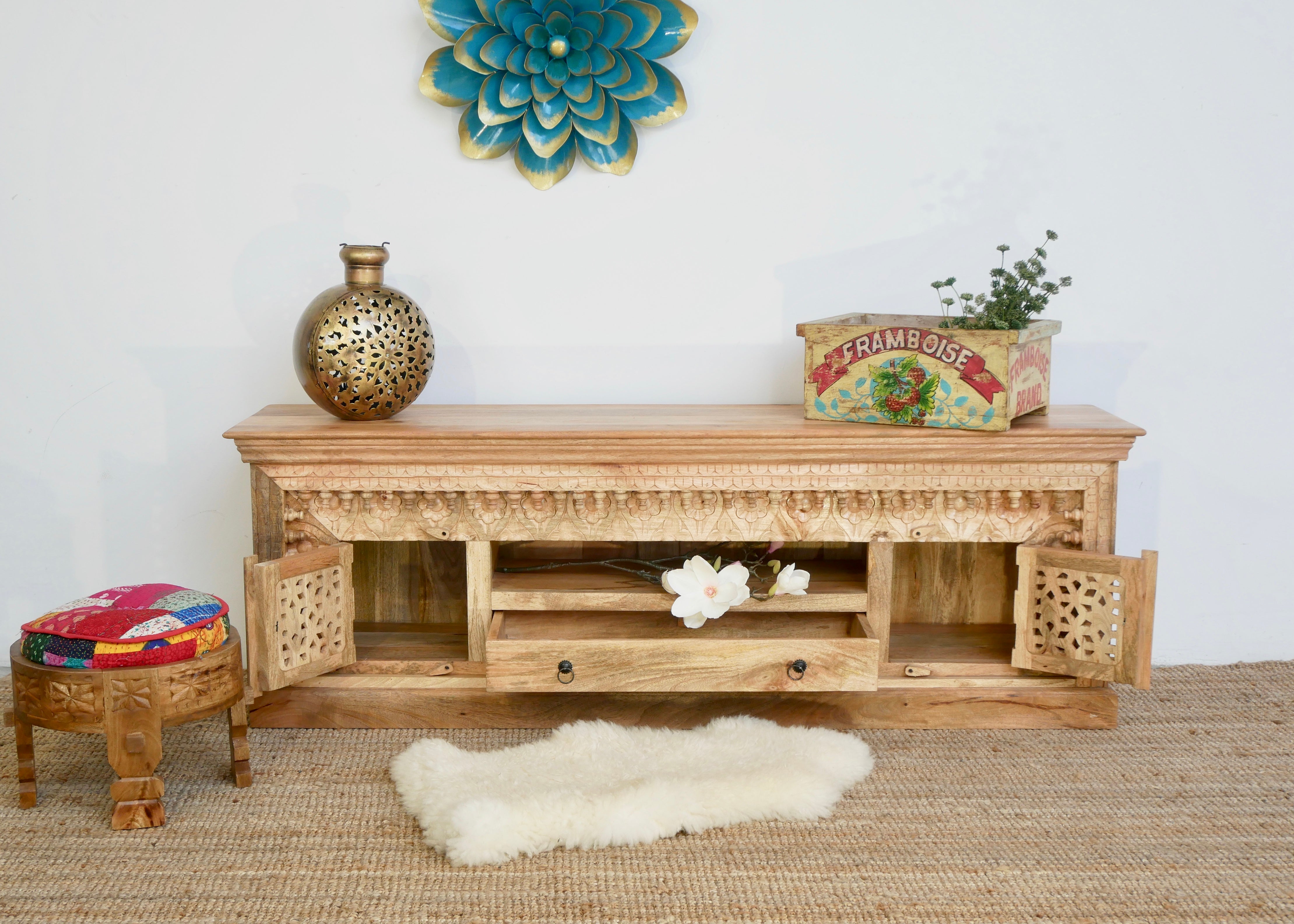 Open door image of a carved mango wood TV unit with hand-carved doors, one drawer, and open shelf, 150 × 60 × 40 cm.