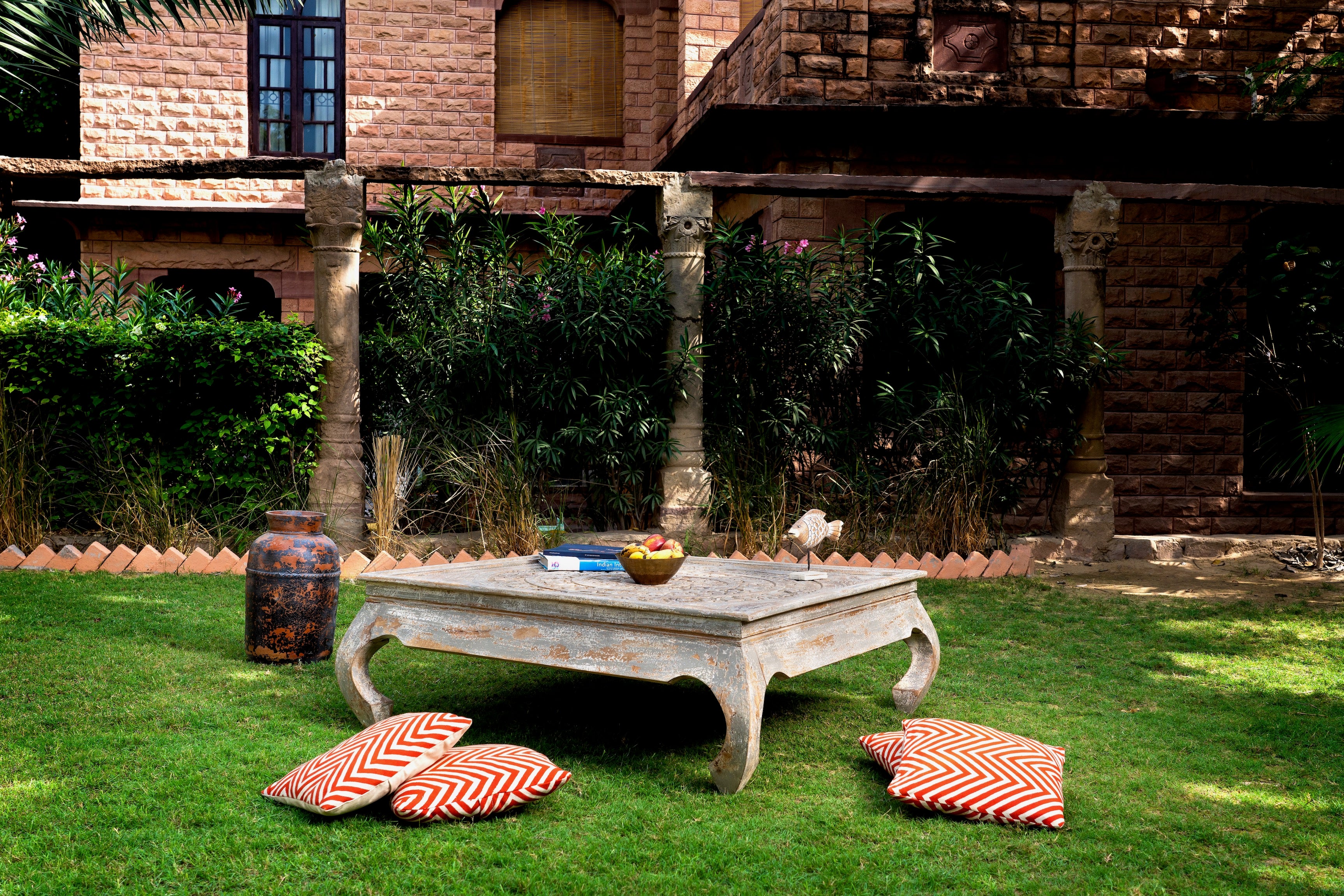 Square hand carved mango wood coffee table with floral top and vintage multi-layer finish; 120 × 120 × 45 cm.