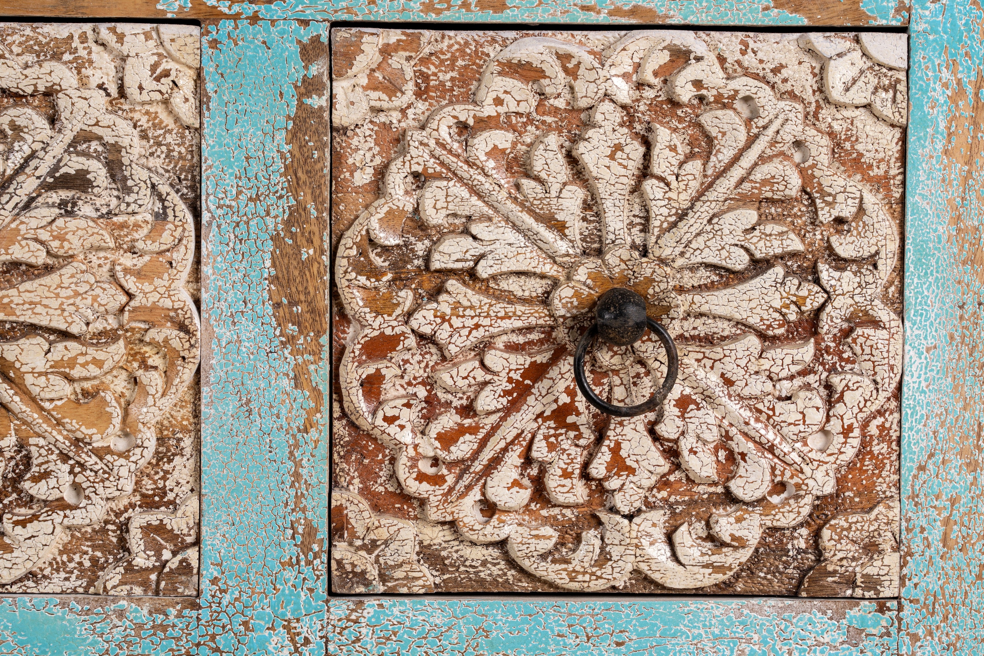 Close up image of a hand-carved mango wood vintage chest of drawers with blue body and whitewashed floral fronts; perfect as an entryway table vintage accent, 90 × 100 × 40 cm.