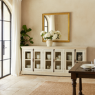 Lifestyle imagination of a sandblasted reclaimed wood sideboard in Ibiza style with four glass-panelled doors, vintage Mediterranean furniture, 263×45×100 cm.