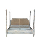 White background image of a King-size four-poster bed frame Aadinath made of solid mango wood with hand-carved twisted posts and cane-panel headboard, shown in a natural washed finish; part of a sustainable wooden canopy bed collection.