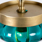 Close up of the top of a retro pendant lamp with large green glass shade and brass-plated iron frame – vibrant glass lamp ideal for dining rooms, living spaces, or bedrooms.