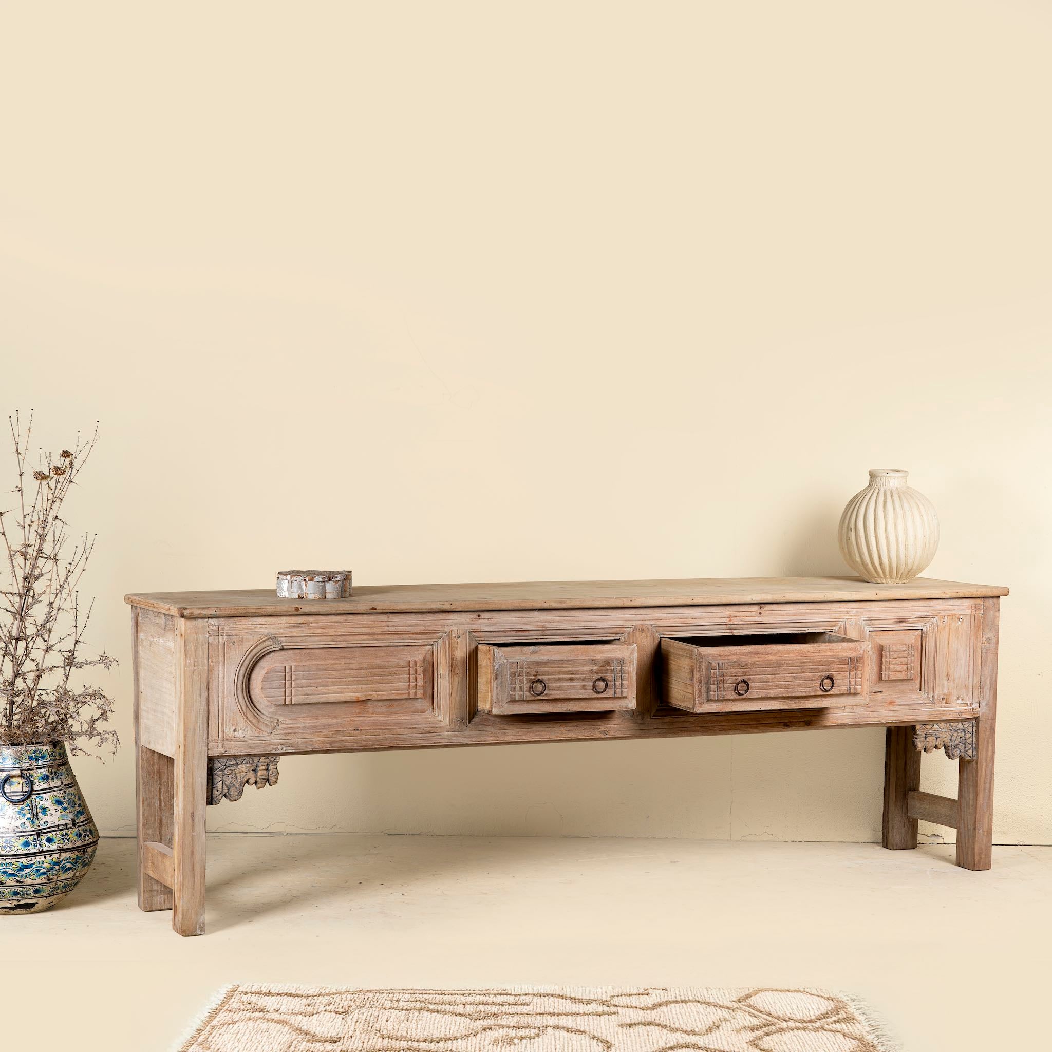 Wooden console table with drawers in a room setting
