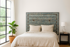 Lifestyle image with a Akshi hand painted head board made from an antique Indian teak door, featuring traditional floral motifs in blue and cream and original iron hardware—an elegant example of hand painted head boards and authentic Indian headboards.