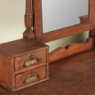 Close up image of a restored antique cosmetic table in teak wood with hand-carved details; teak wood furniture for bohemian interiors, 105 × 56 × 148 cm.