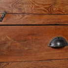 Close up image of an antique reclaimed teak wood display cabinet with glass door, honey wax finish, and lower drawer – unique furniture showcasing traditional Indian craftsmanship.