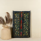 Decorative wall panel made from an old teak wood window frame, hand-painted with intricate floral patterns in vibrant colours including green, red, yellow, and blue, showcasing traditional Indian craftsmanship and vintage charm.
