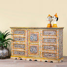 Side angle image of a hand-painted reclaimed wood sideboard with floral motifs – a unique piece of sustainable furniture for vibrant Indian home decor.
