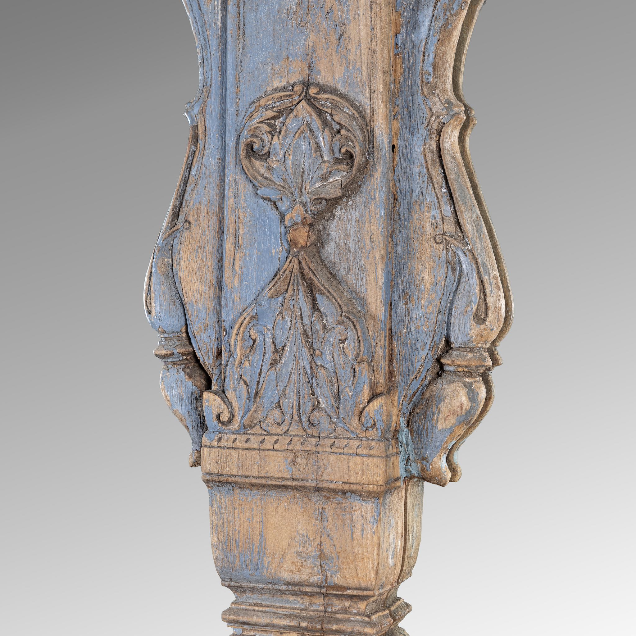 Close up picture of a vintage two-arch mirror crafted from reclaimed teak wood, with hand-carved details and a weathered blue patina finish.