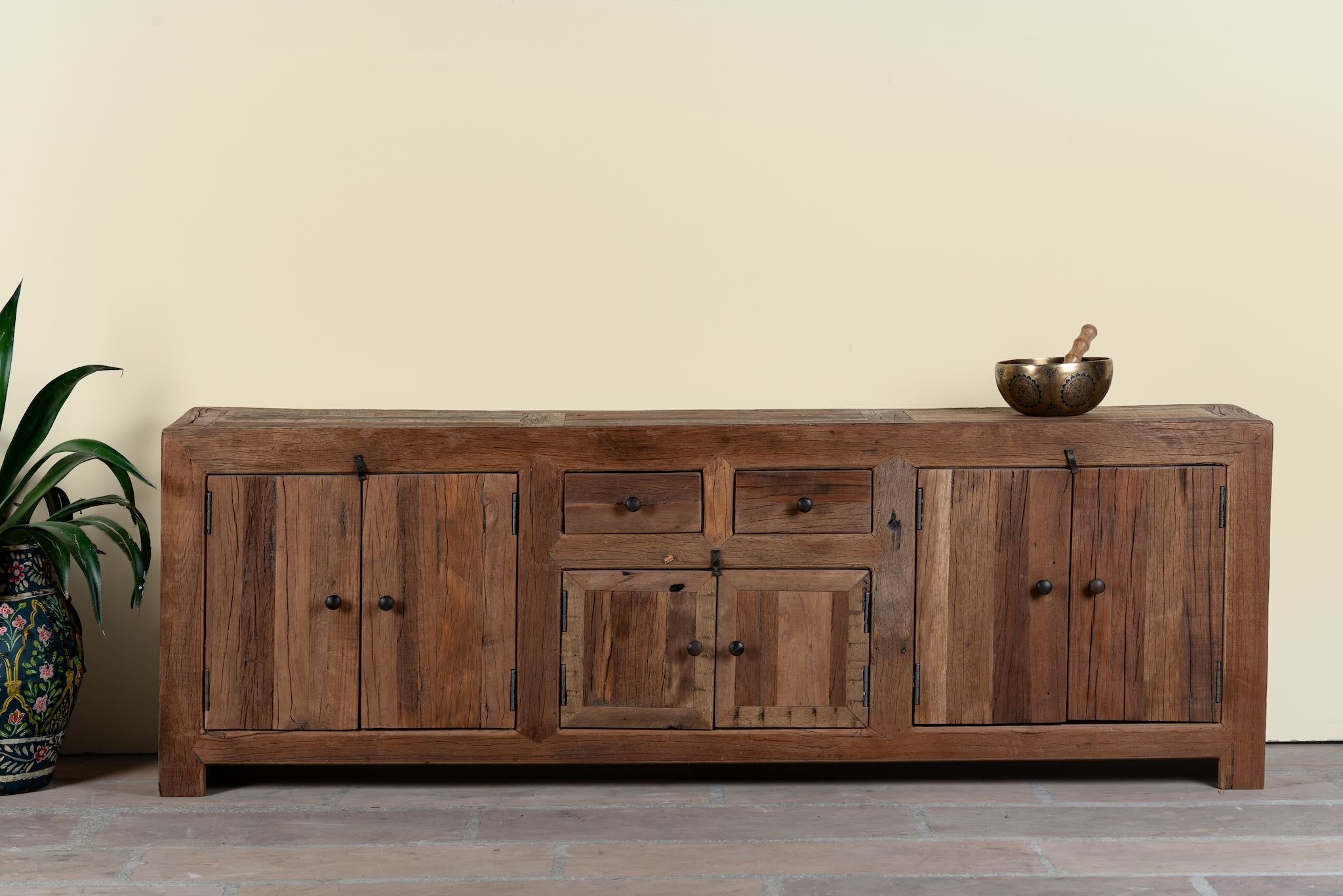 Reclaimed wood lowboard Ariana in rustic minimalistic style with four cabinets and two drawers. A sustainable furniture piece offering functional storage and natural texture for modern living spaces.