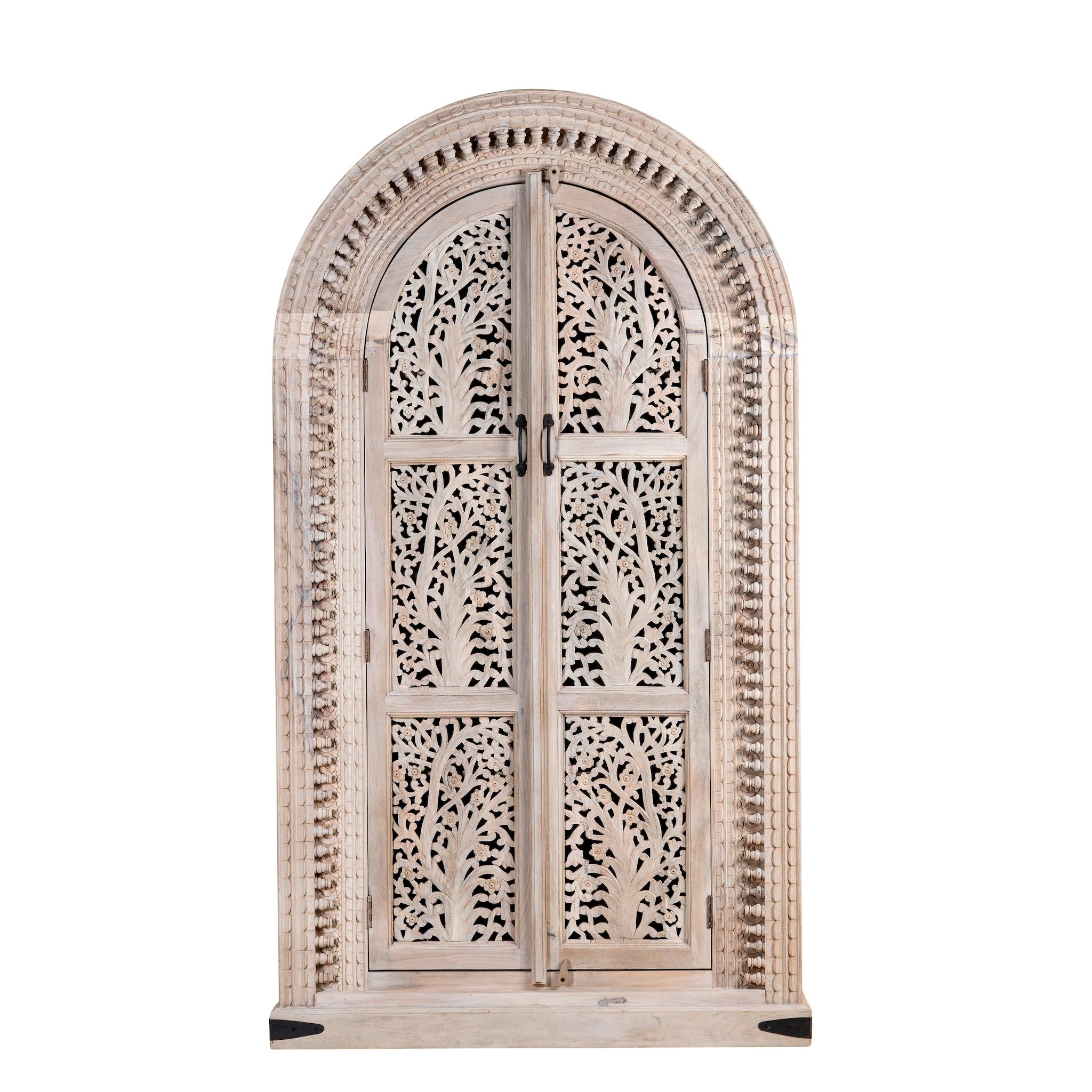 White background picture of a mango wood cabinet with intricately hand-carved doors and an arched half-round top, showcasing a detailed tree motif and traditional Indian craftsmanship.