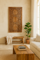 Lifestyle scene with a hand-carved mango wood wall panel with floral engravings in natural finish – Arusha model by Om Home & Garden