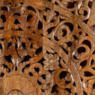 Close up image of a hand-carved mango wood wall panel in natural finish with floral designs – Asamanja model by Om Home & Garden